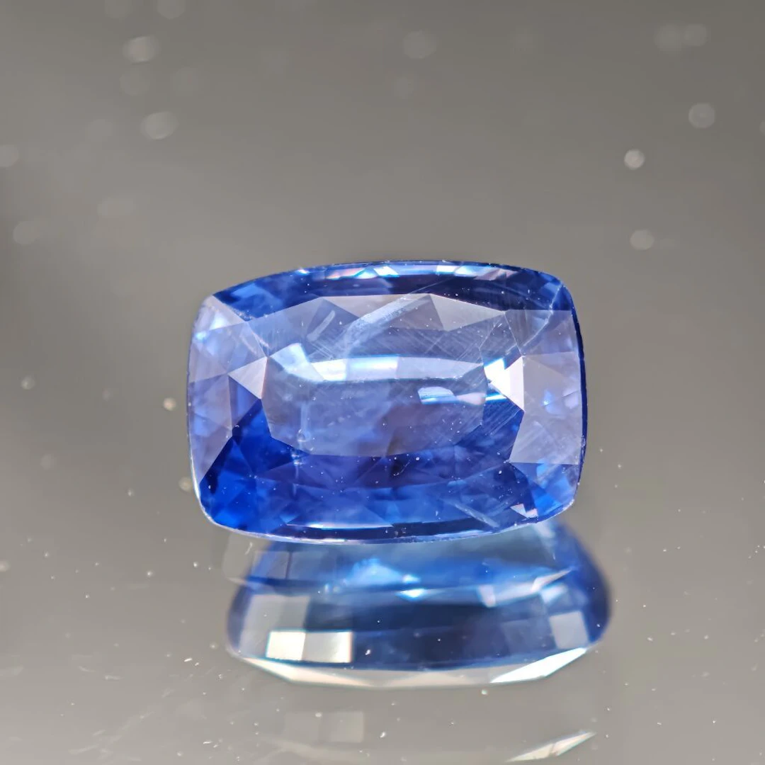 Cushion-cut sapphire, weighing 3.39 carats. Dimensions: 12 x 7.1 x 4.8 mm