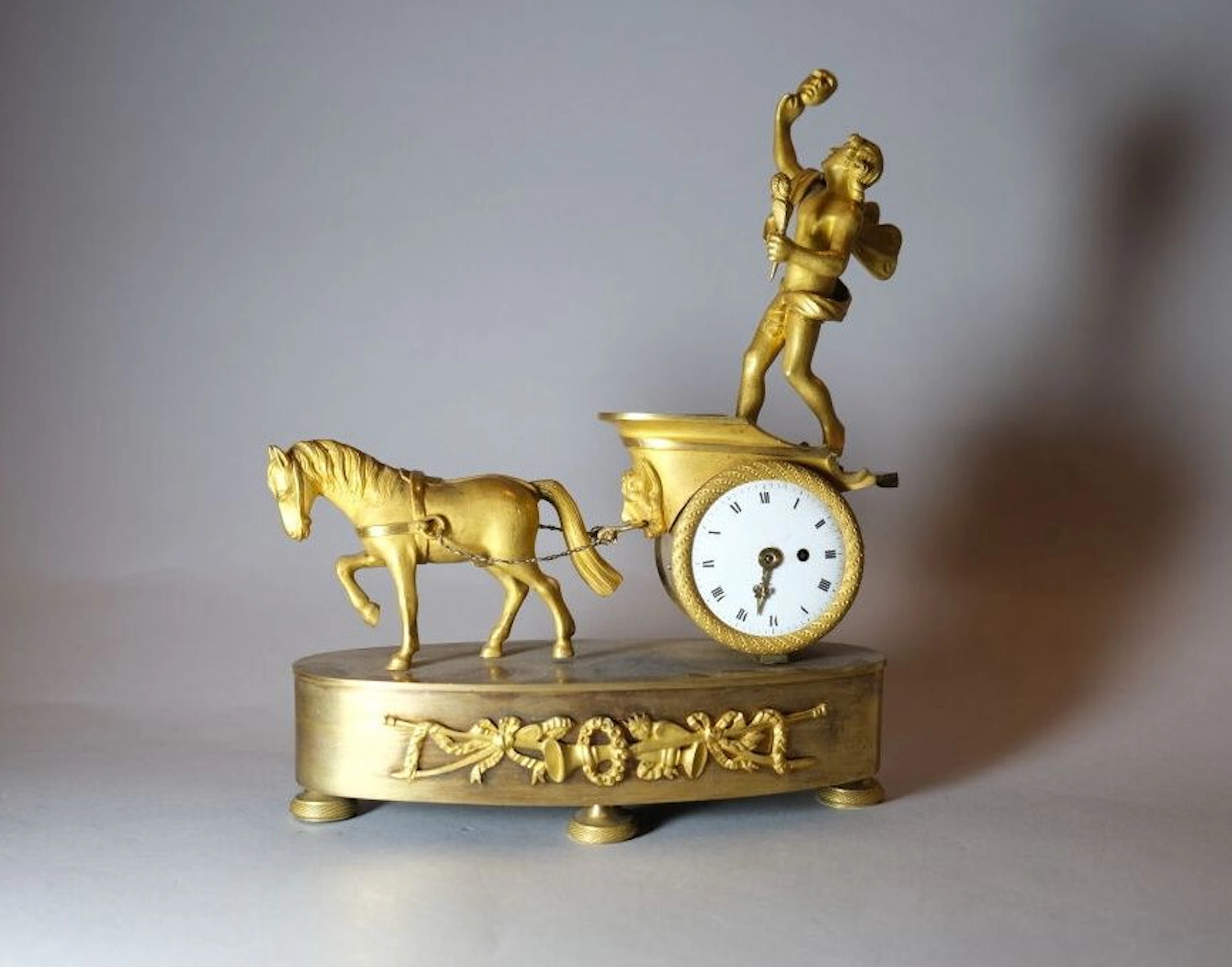 A Louis XVI-style gilded bronze table clock depicting Zephyr on a