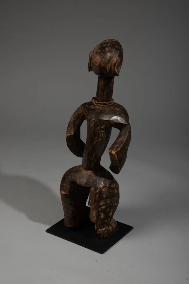 A standing sculpture in a dynamic pose, with outstretched, embracing