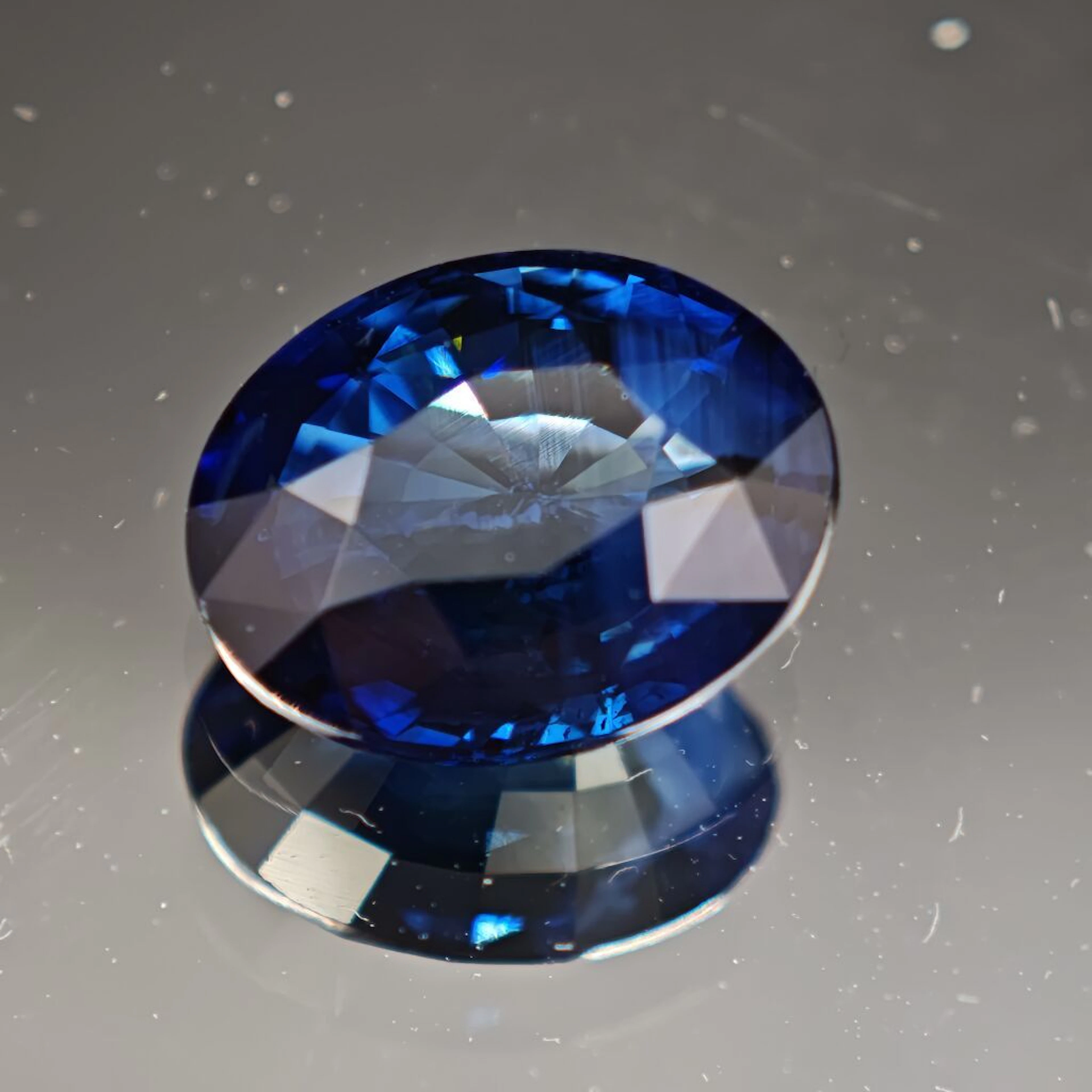Oval-shaped sapphire, deep blue in color with a hint of green. Weight: