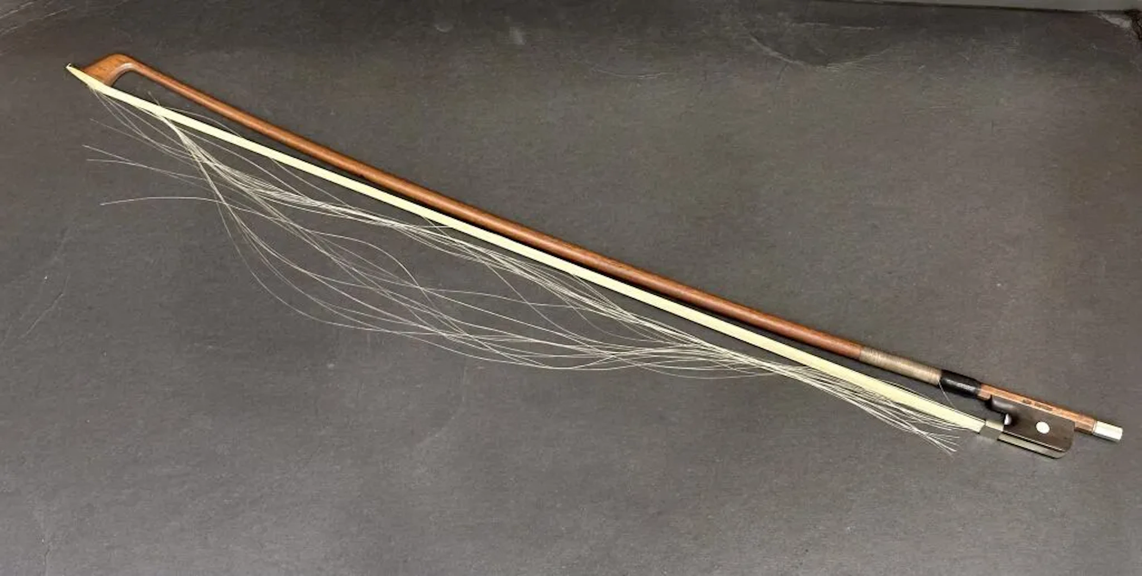 Cello bow stamped "ARY FRANCE." Length: 72 cm. Weight: 85.84 g. (Strings