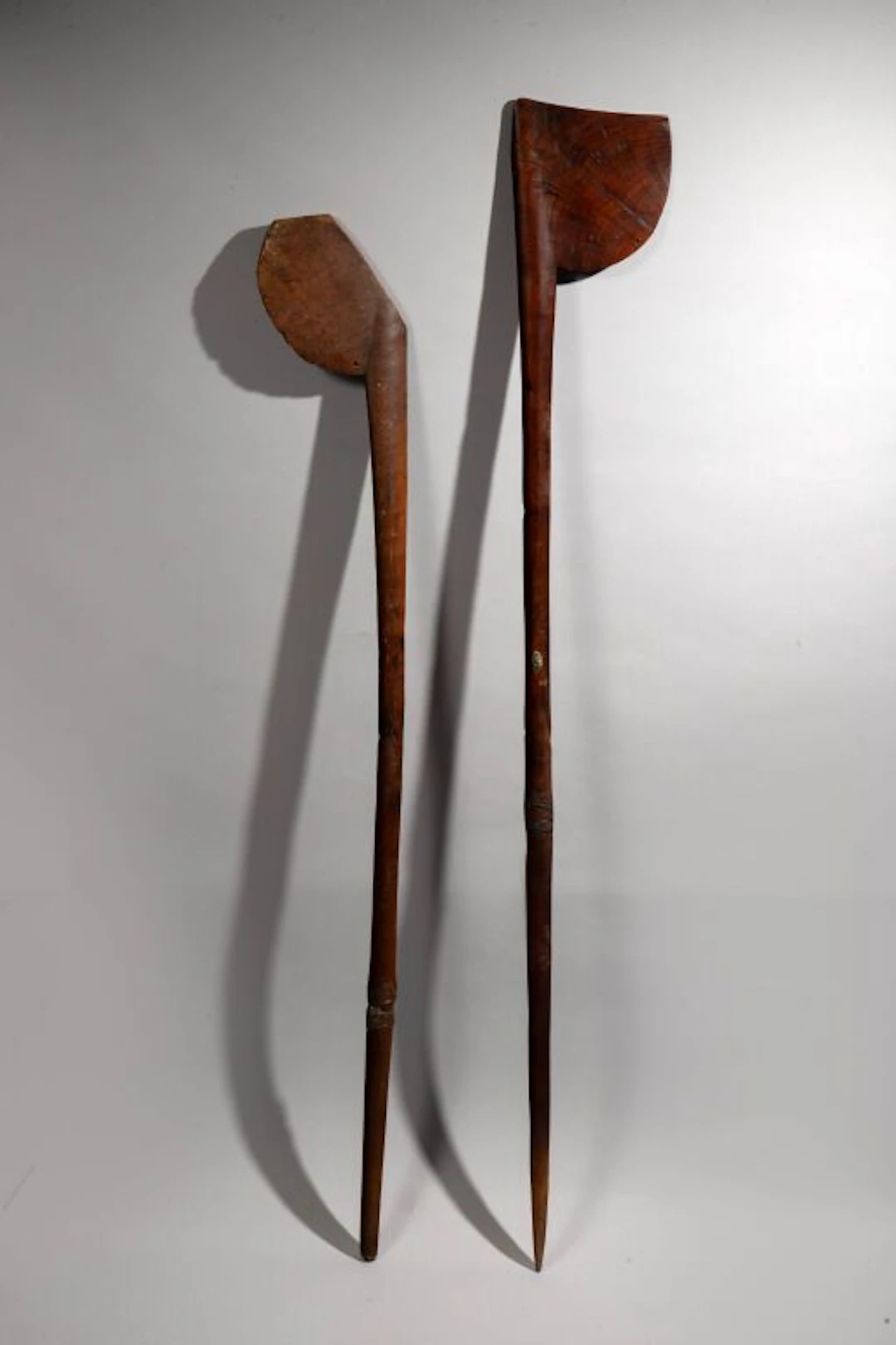 A Tewa-Tewa war club decorated with a depiction of Tiki on the handle.