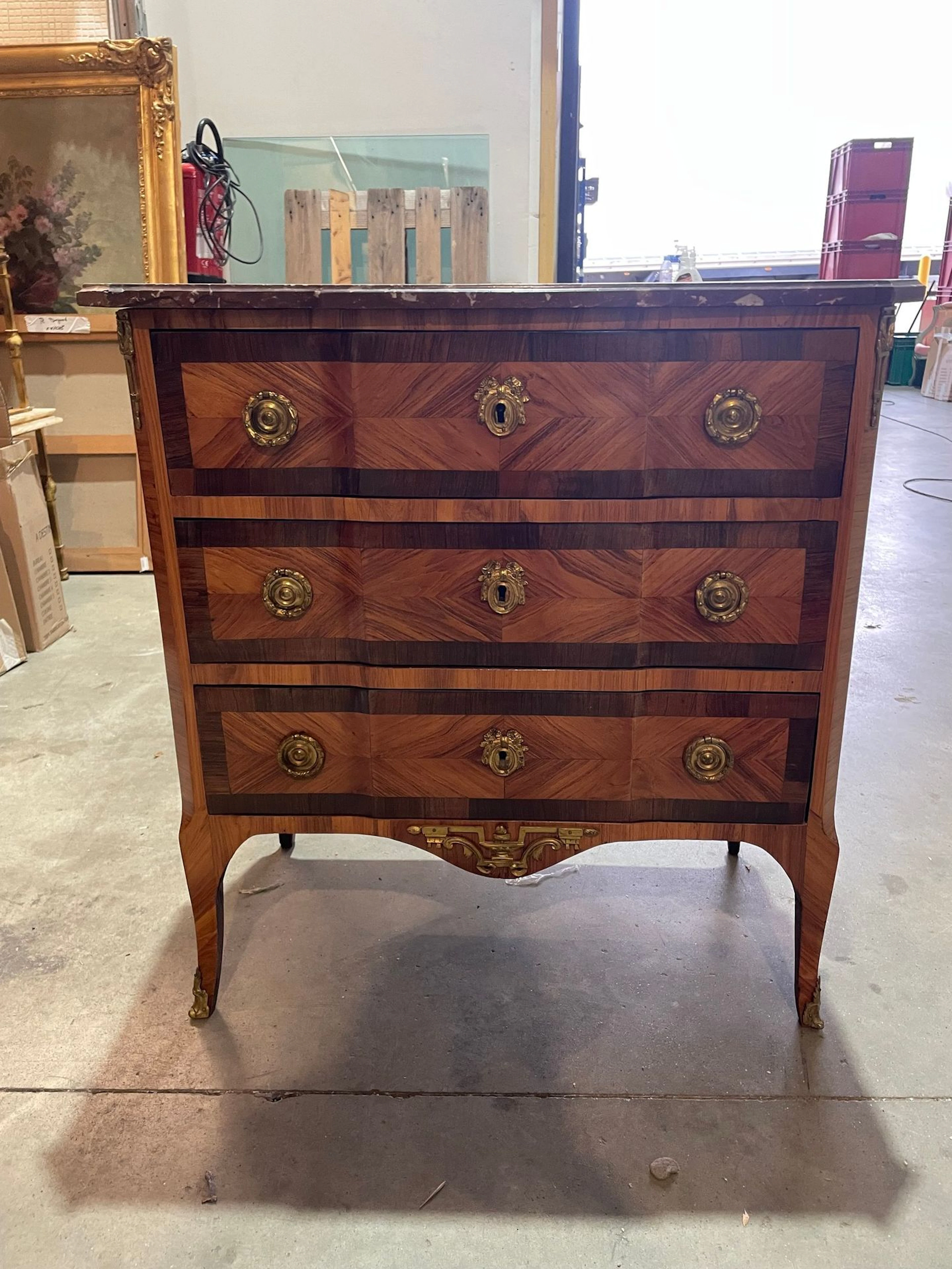 A slightly projecting chest of drawers made of solid wood and wood