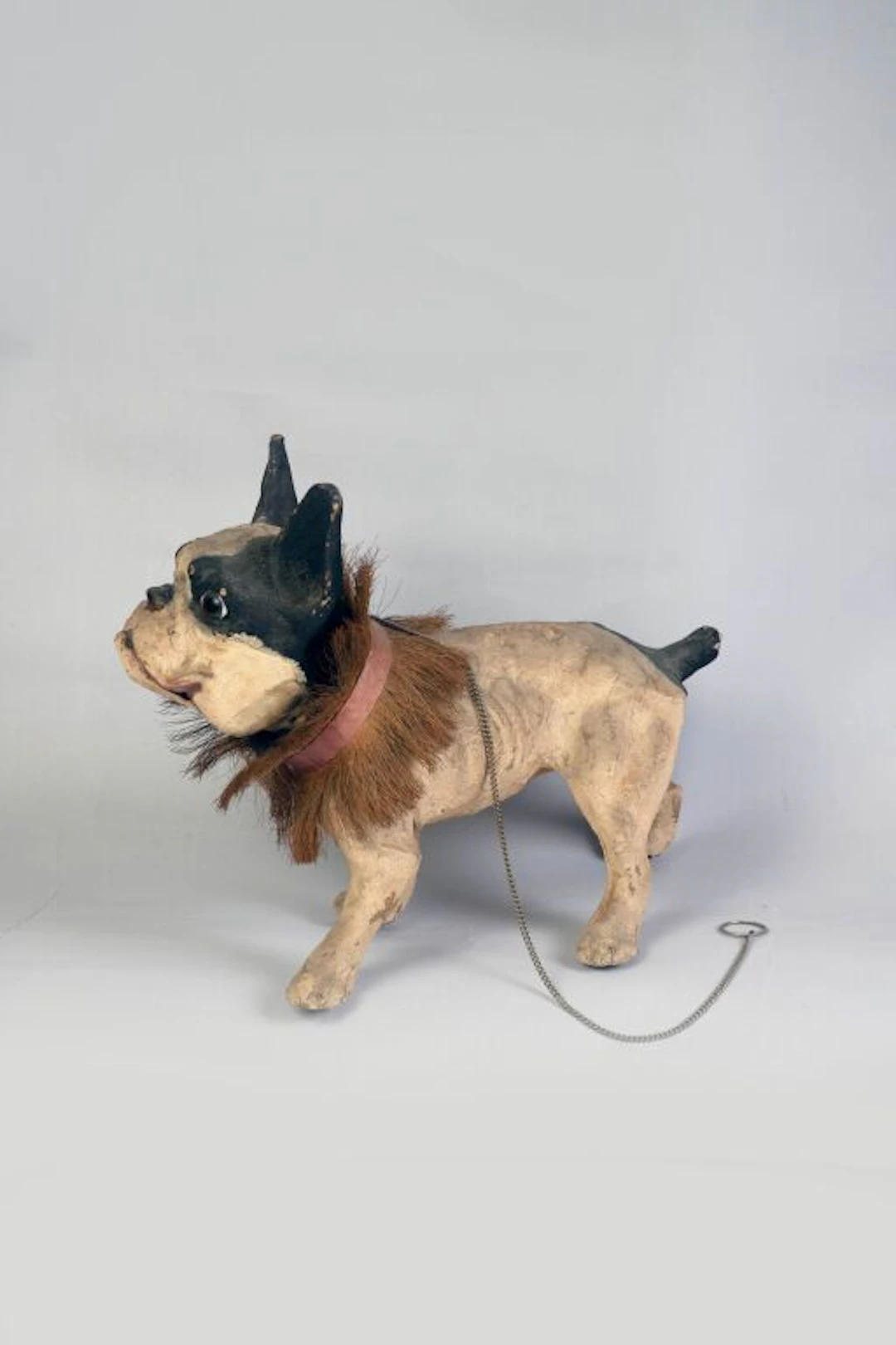 A barking bulldog made of papier-mâché and painted in multiple colors