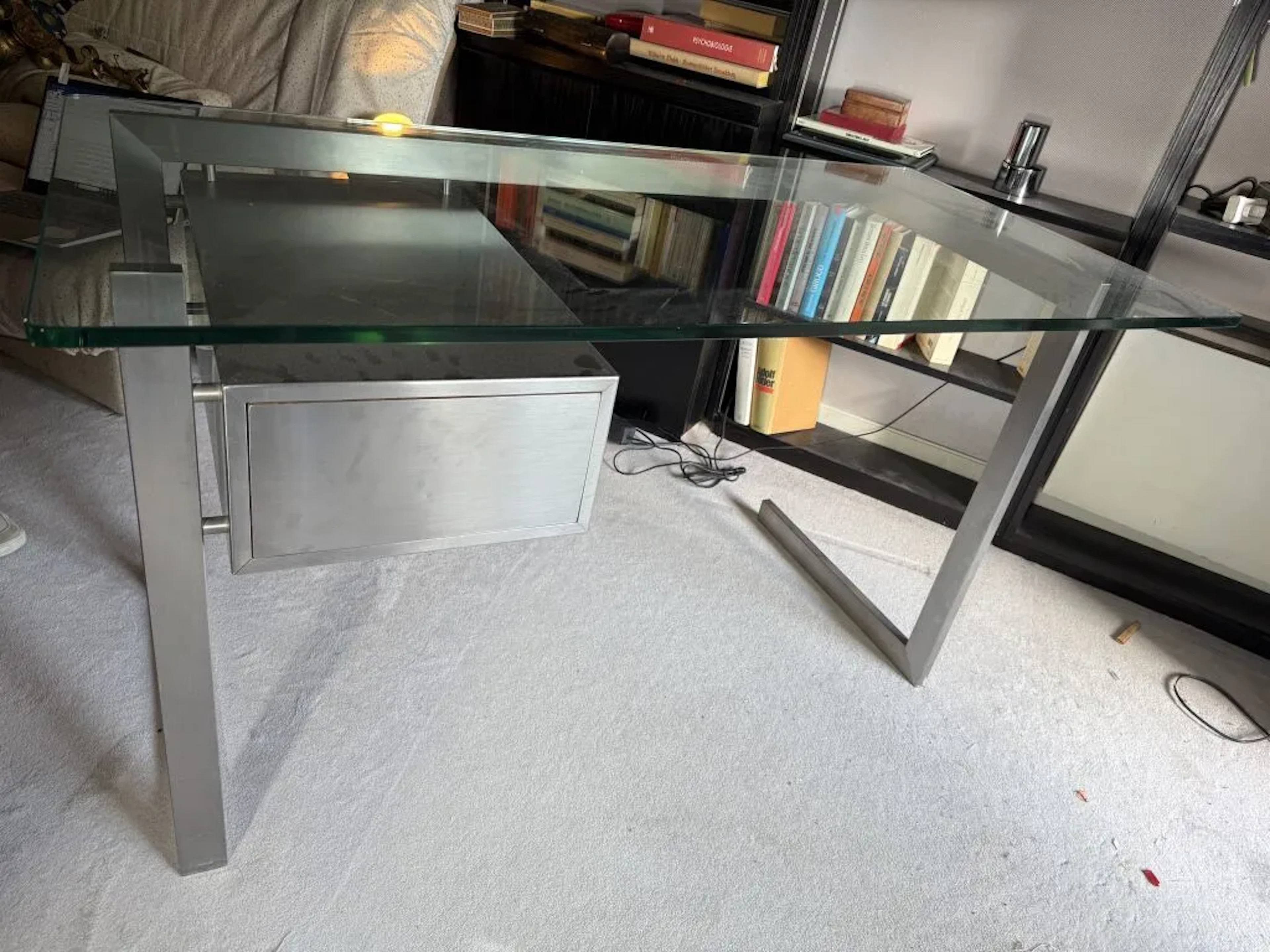 Small designer desk made of brushed aluminum, featuring an oak drawer
