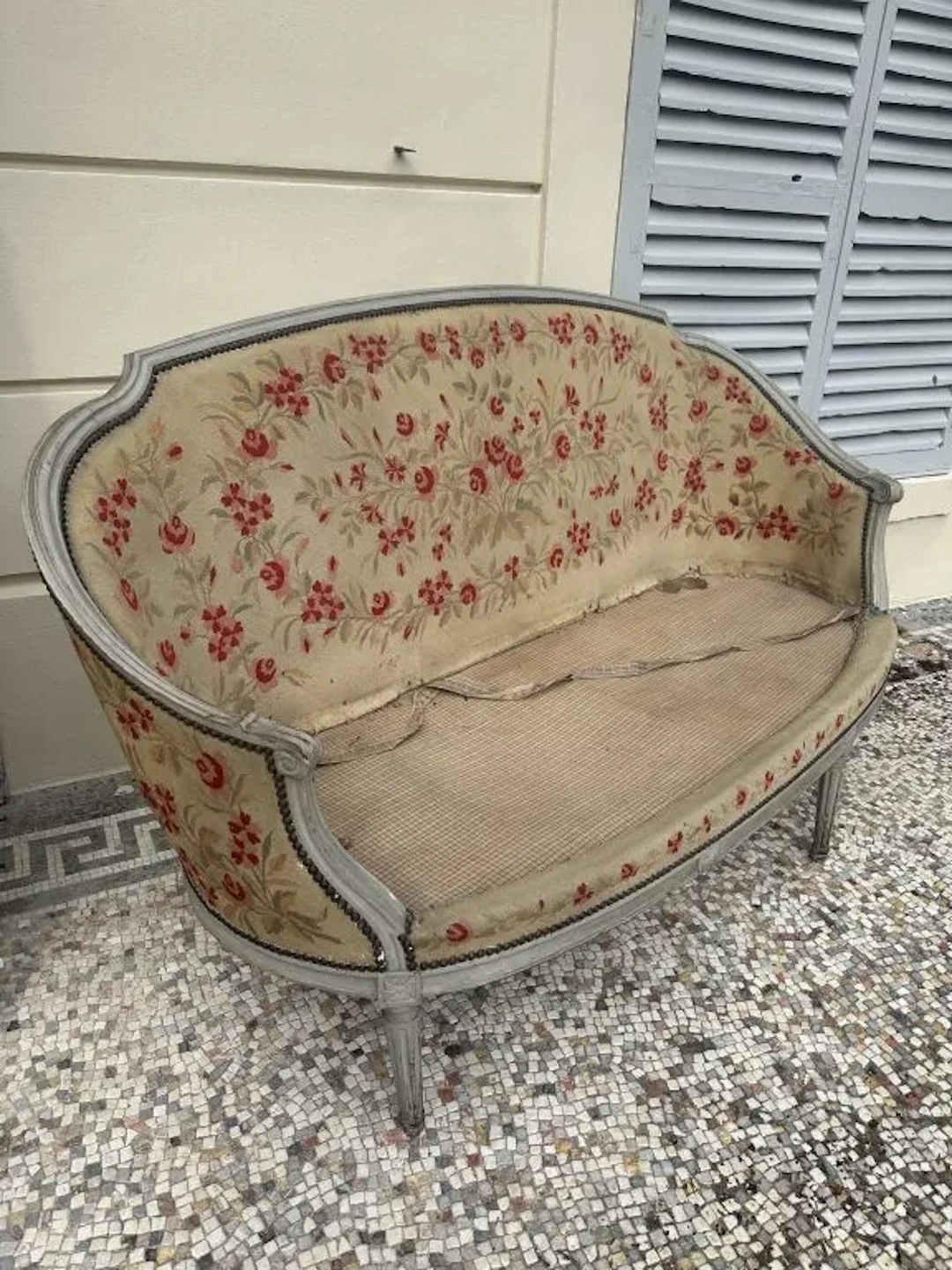 Wicker sofa with a wraparound backrest made of molded wood and refinished