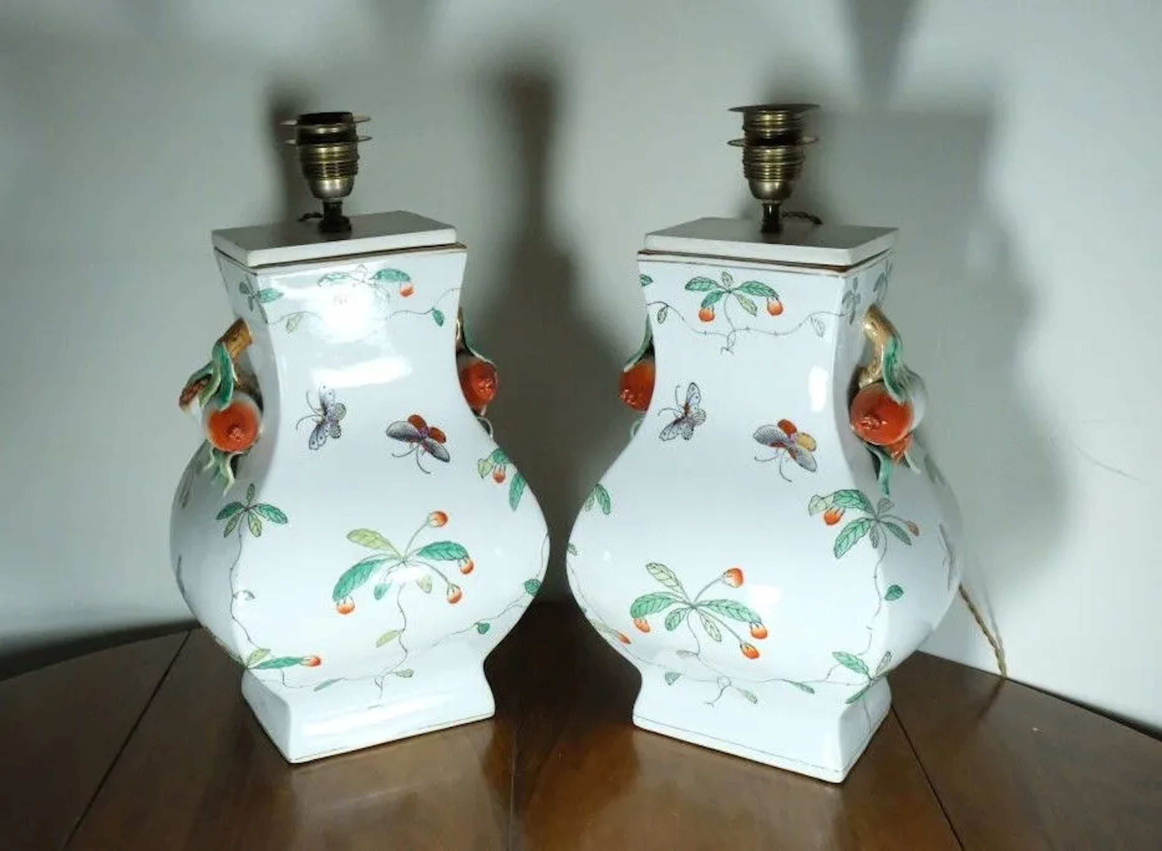 A striking pair of porcelain living room lamps with polychrome decoration