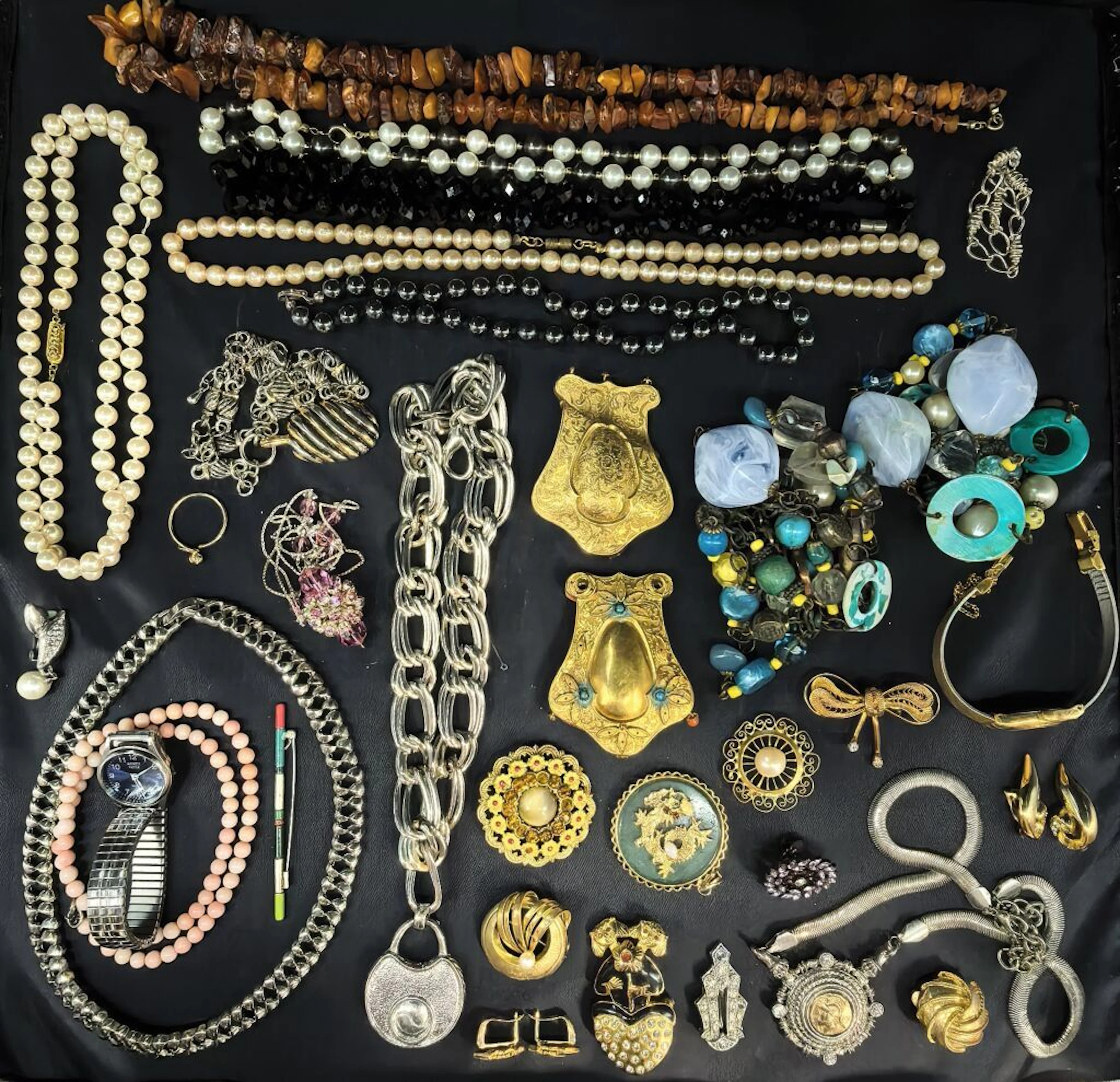 A collection of costume jewelry and metal watches, including bracelets