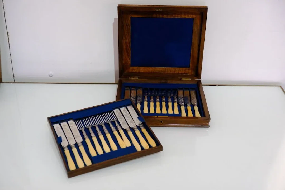 A set of twelve dessert knives and twelve dessert forks in silver-plated