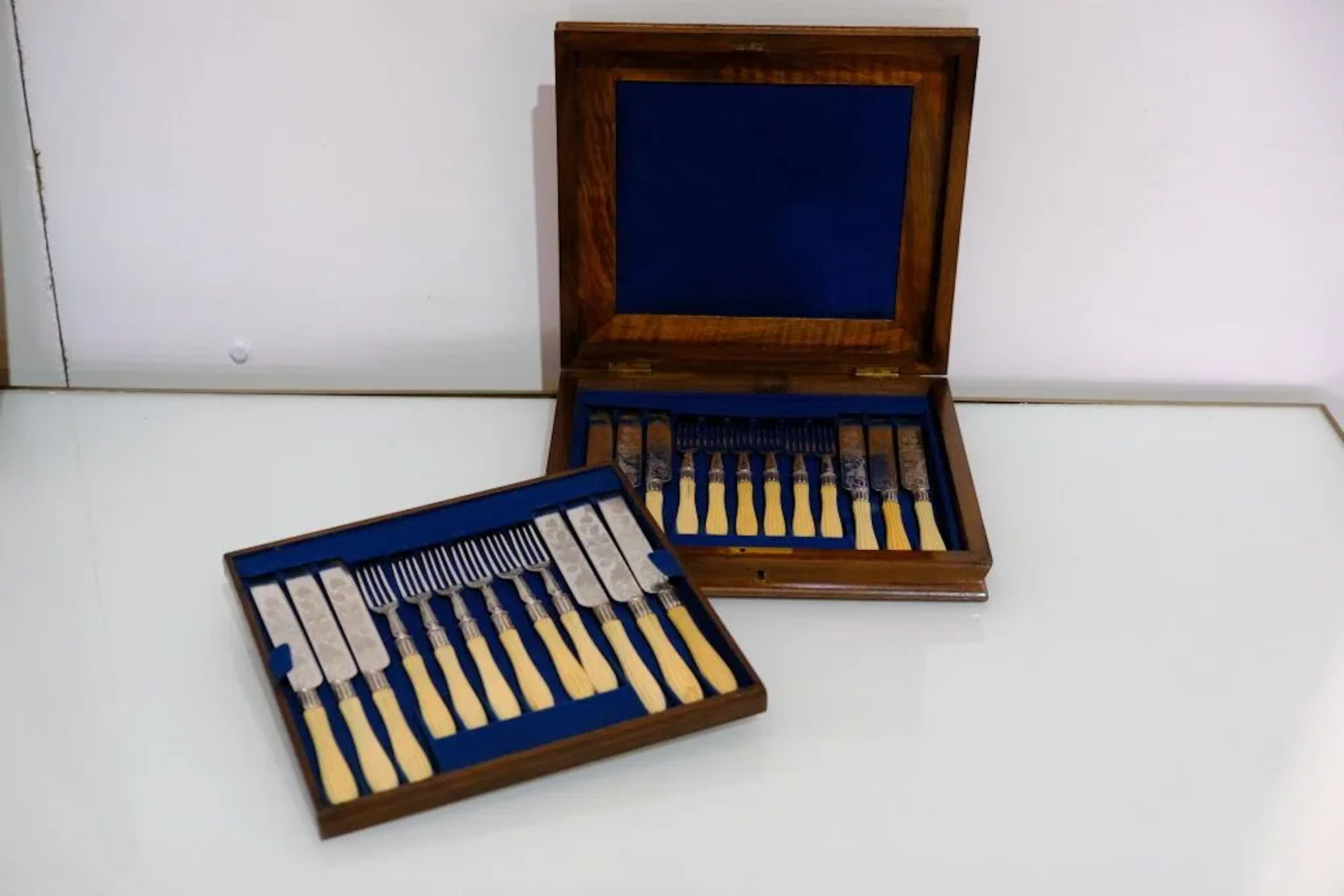 A set of twelve dessert knives and twelve dessert forks in silver-plated
