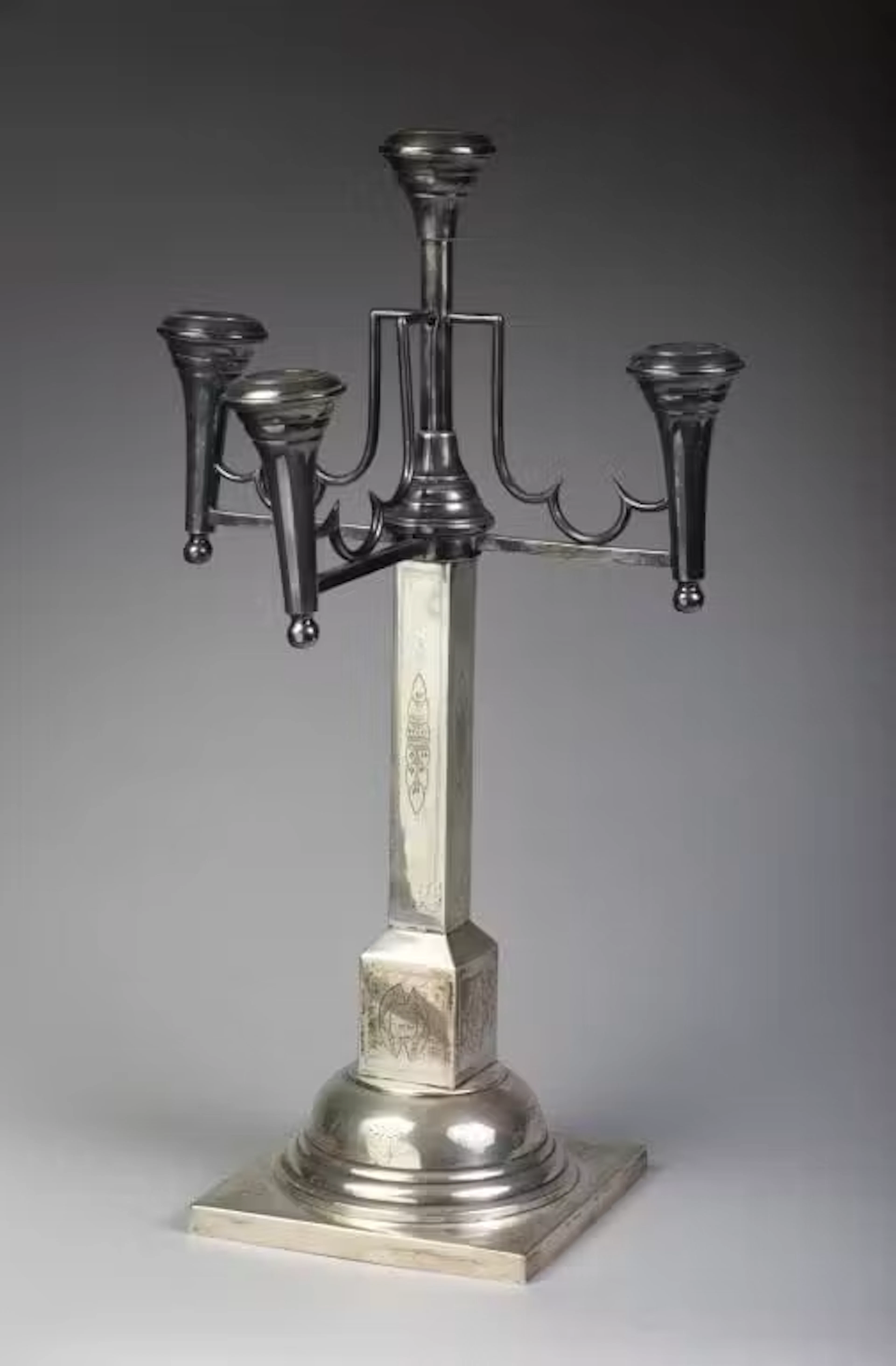 A large four-arm candelabra made of 800‰ silver. The quadrangular