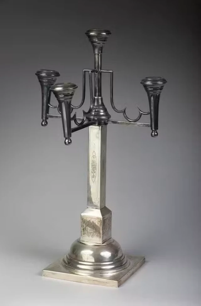 A large four-arm candelabra made of 800‰ silver. The quadrangular