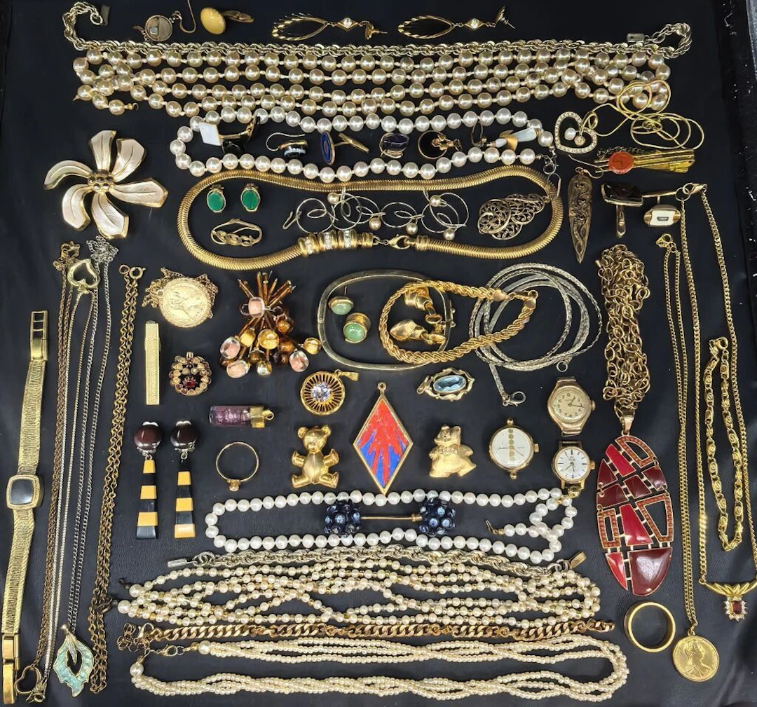 A collection of costume jewelry and watches made of metal, gold-plated