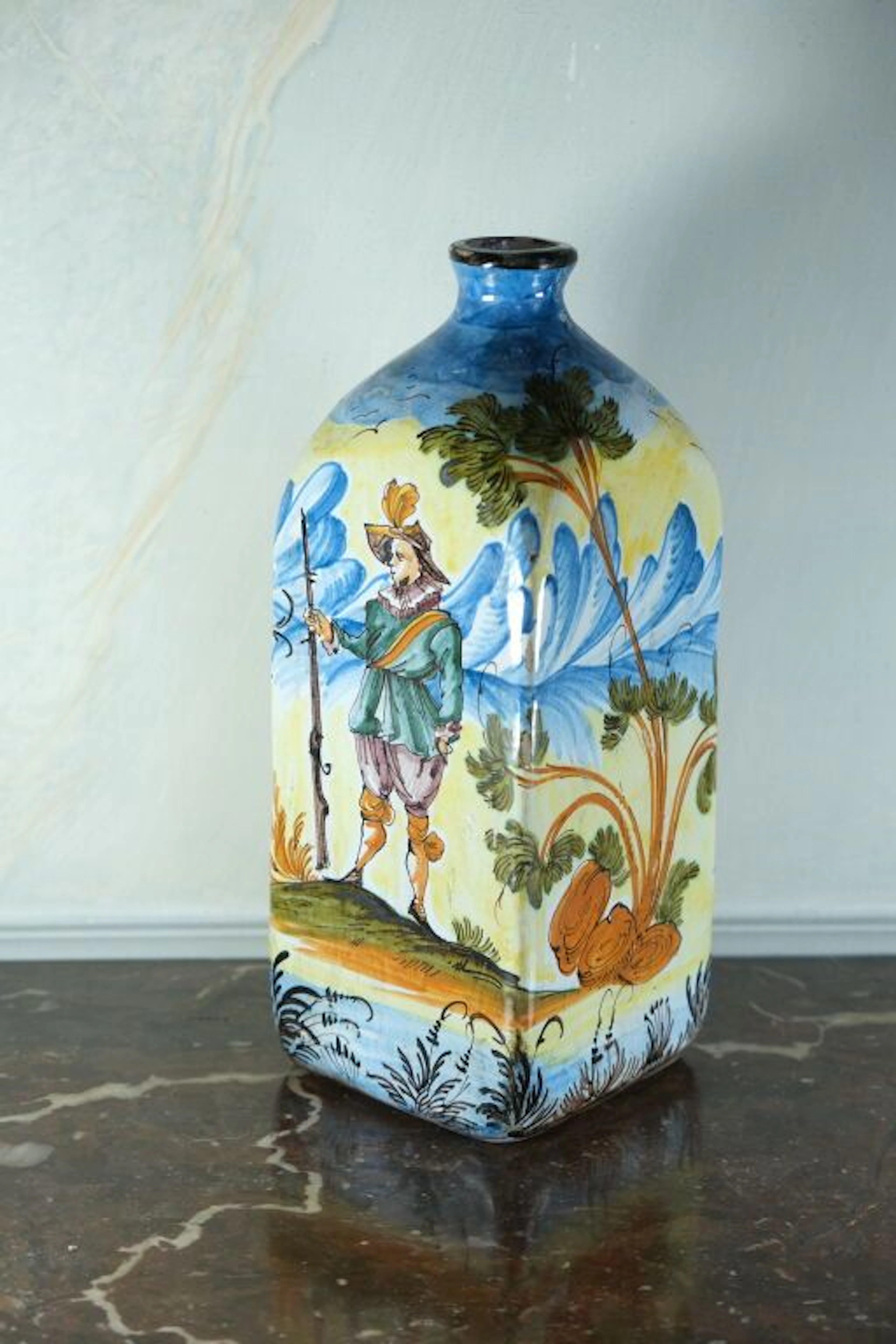 Earthenware bottle with polychrome decoration depicting a hunter and