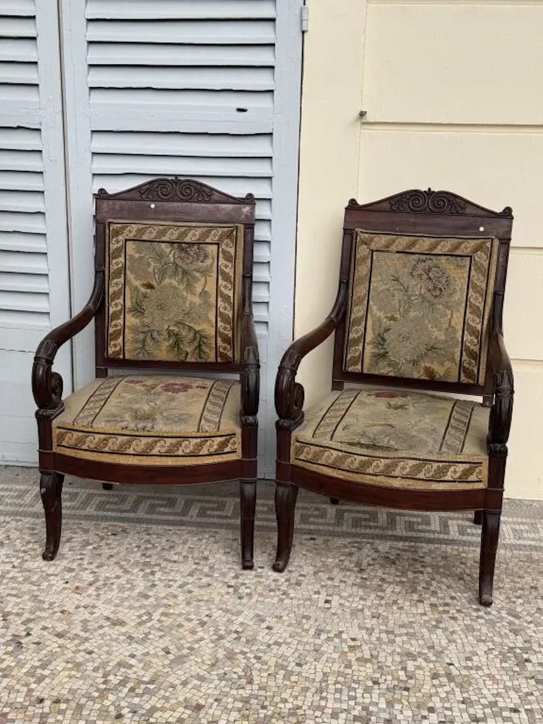 Pair of mahogany and mahogany-veneered armchairs carved with foliage