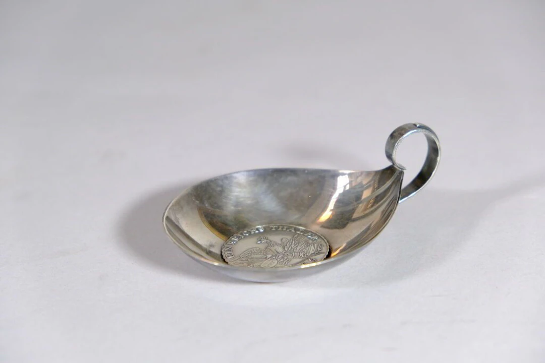 GERMANY. Tastevin, with a 925/1000 silver setting featuring a central