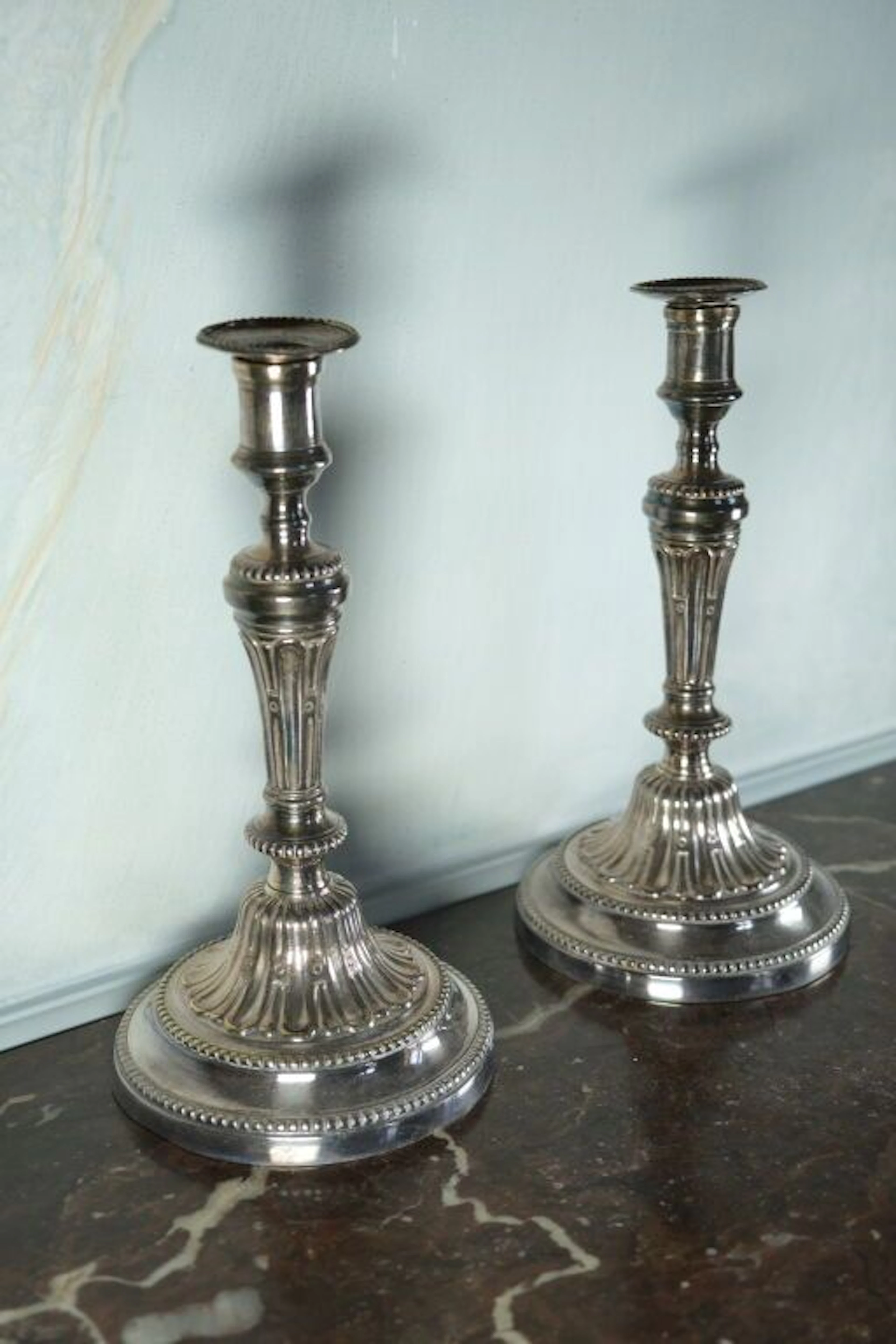 Pair of silver-plated bronze candlesticks with their candle holders.