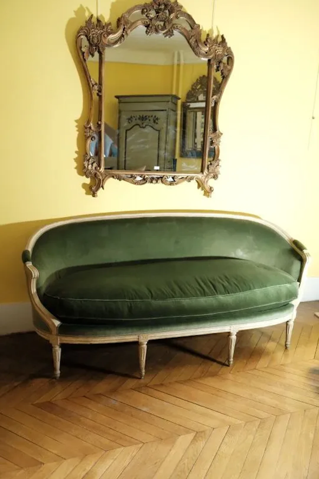 Wooden sofa with molded and carved rosette detailing at the joint.