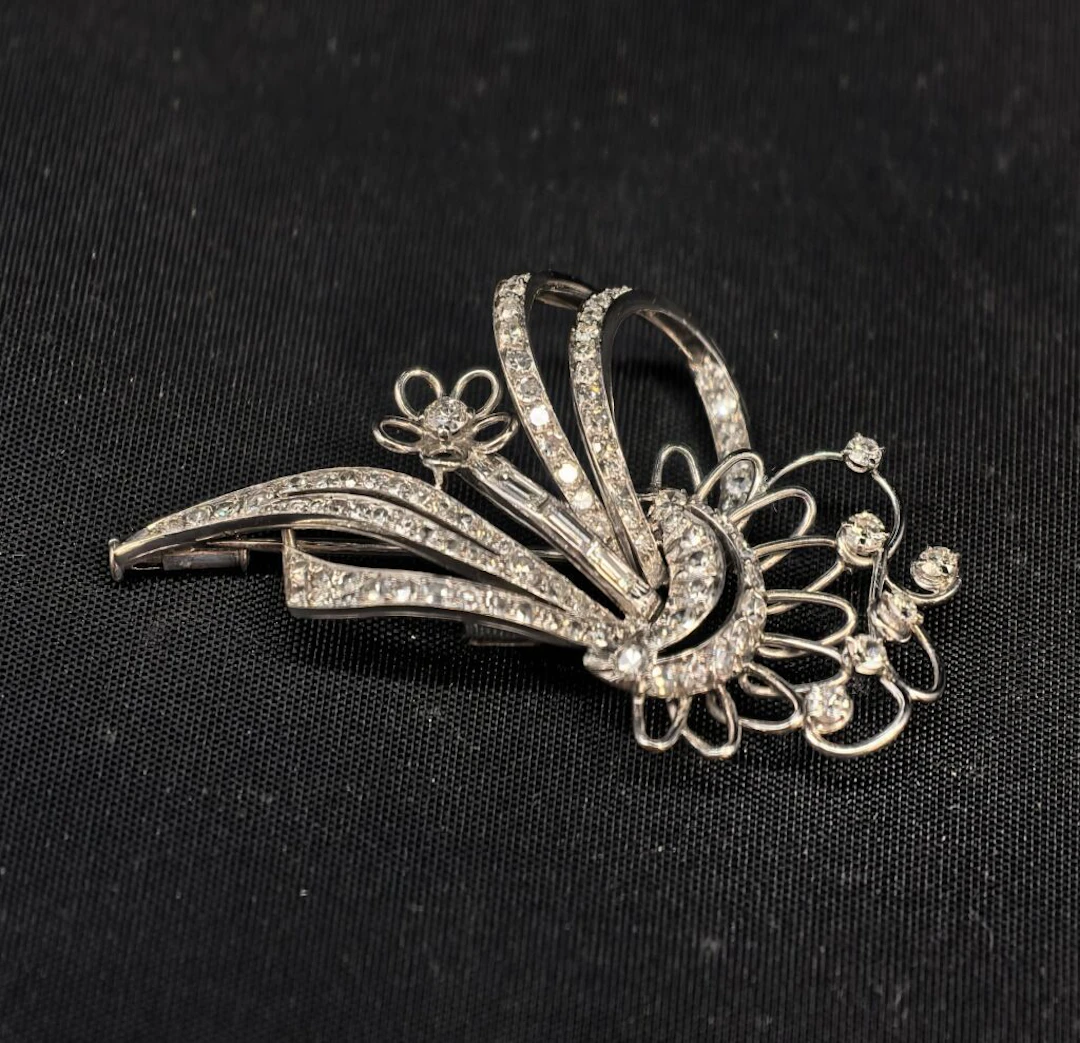 * Part of a double-clip brooch made of 950‰ platinum and 750‰ white