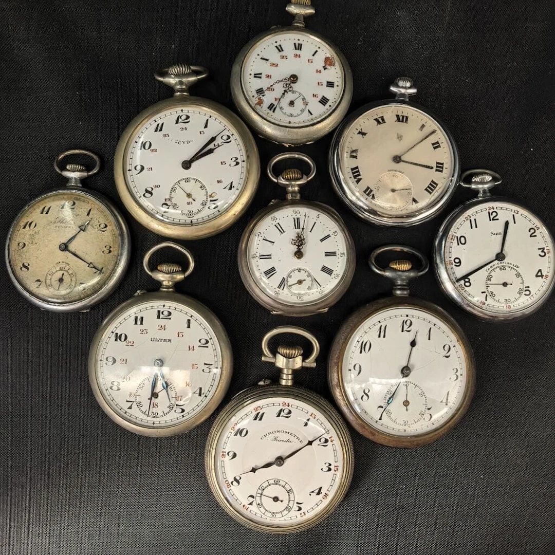 A set of nine pocket regulators, including one in silver with a gross