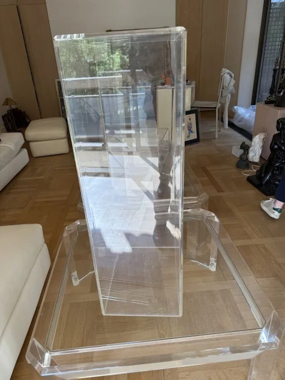 Tall cabinet, TV stand, and accessory made of Plexiglas on casters.