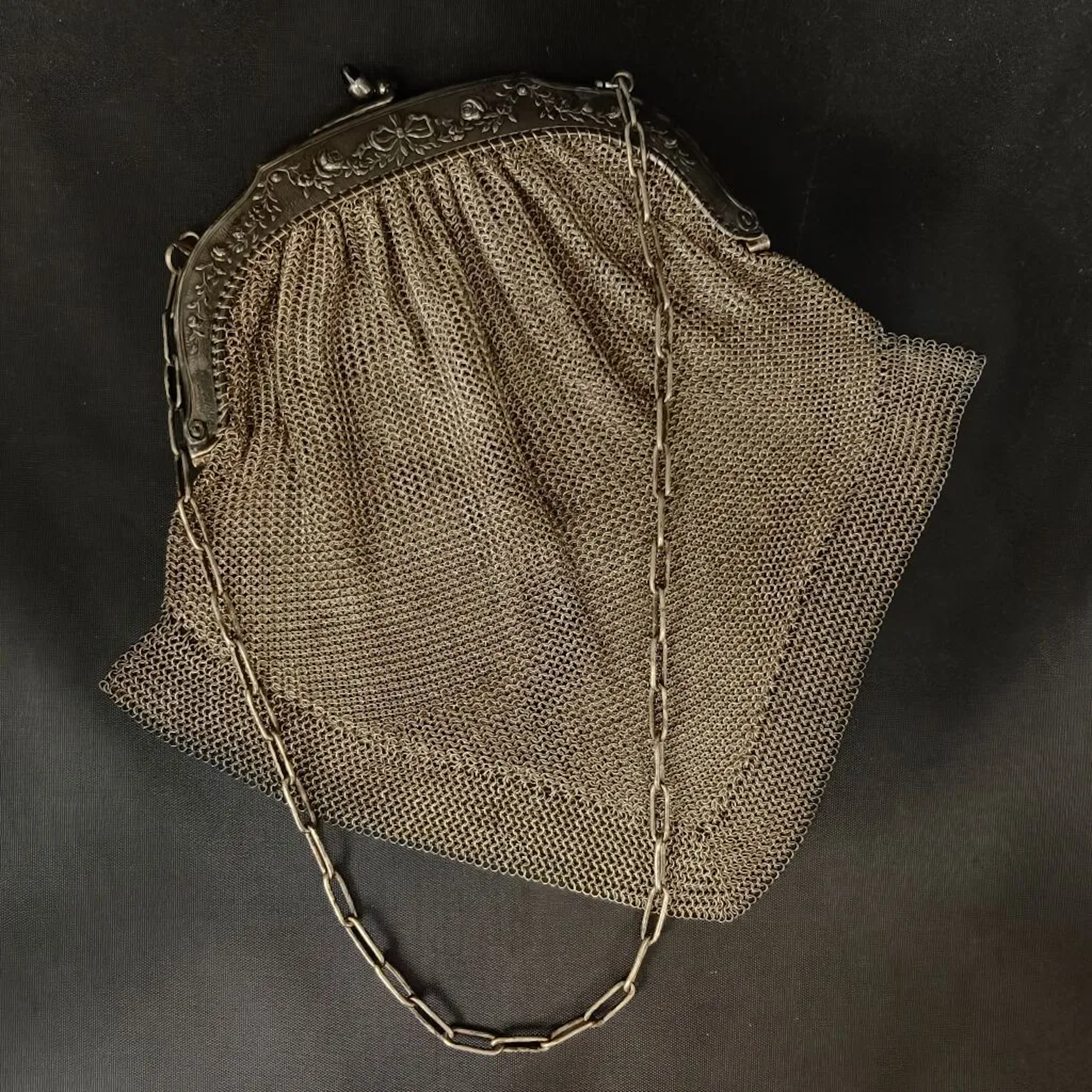 Silver plated metal evening bag in a "chain mail" style, with a frame