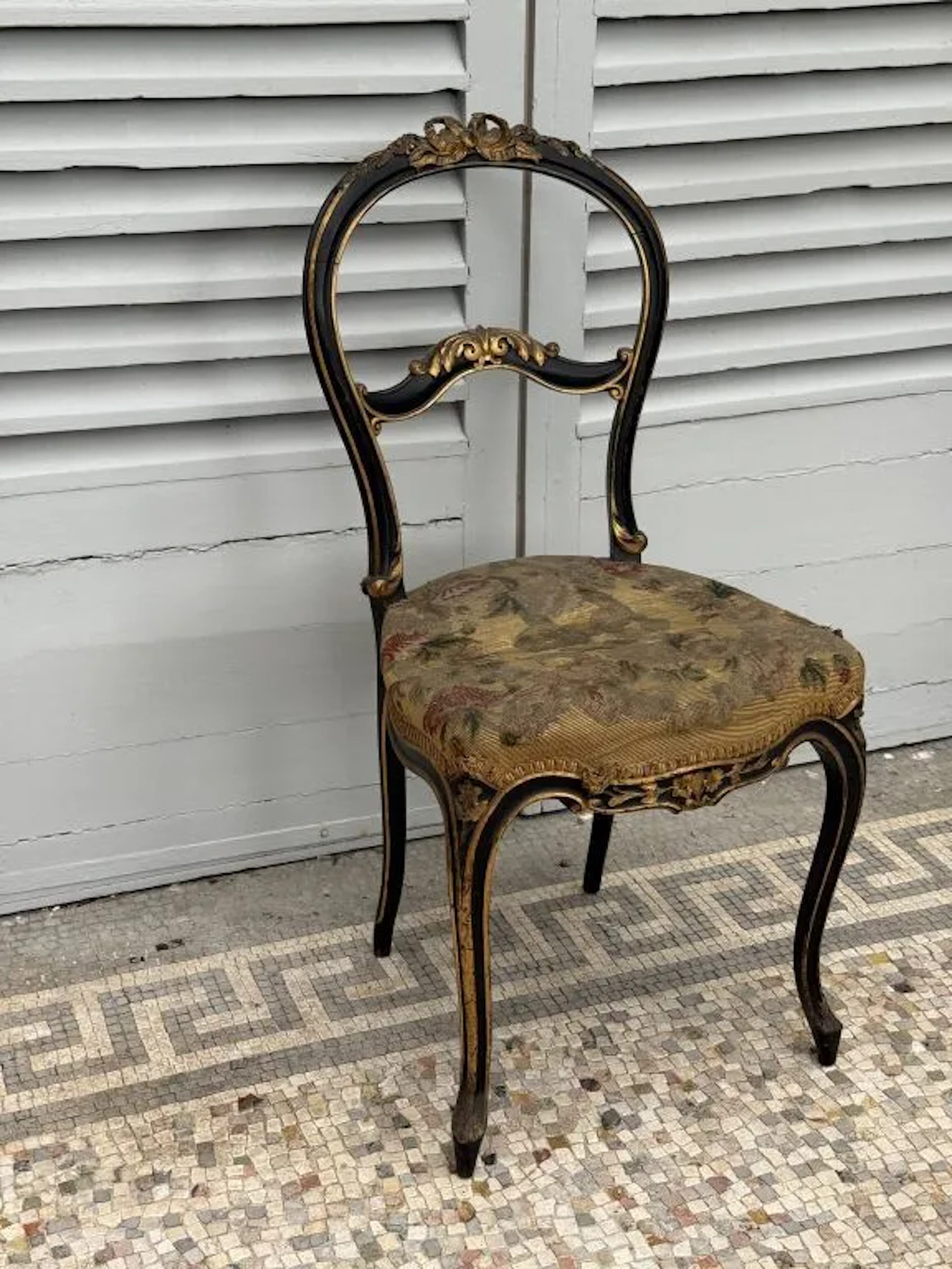 Small wingback chair for the parlor or theater, with an openwork cabriolet
