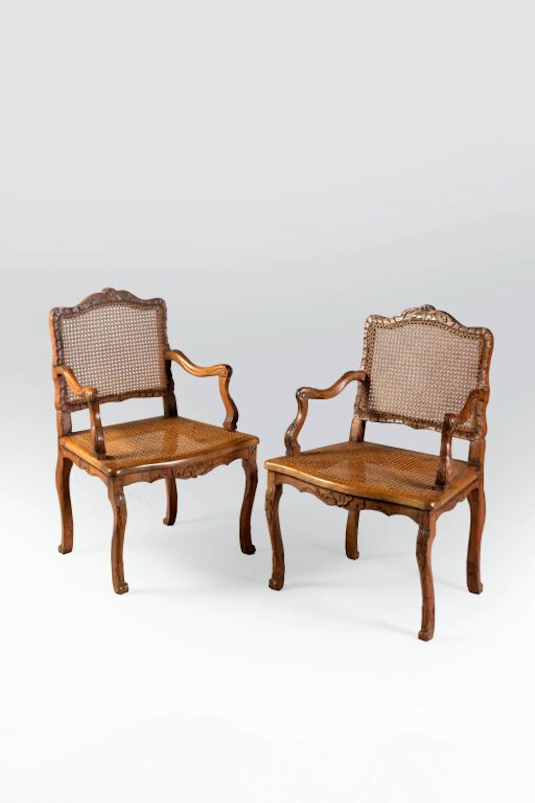 Pair of finely carved beech cane armchairs with rocaille motifs. Console