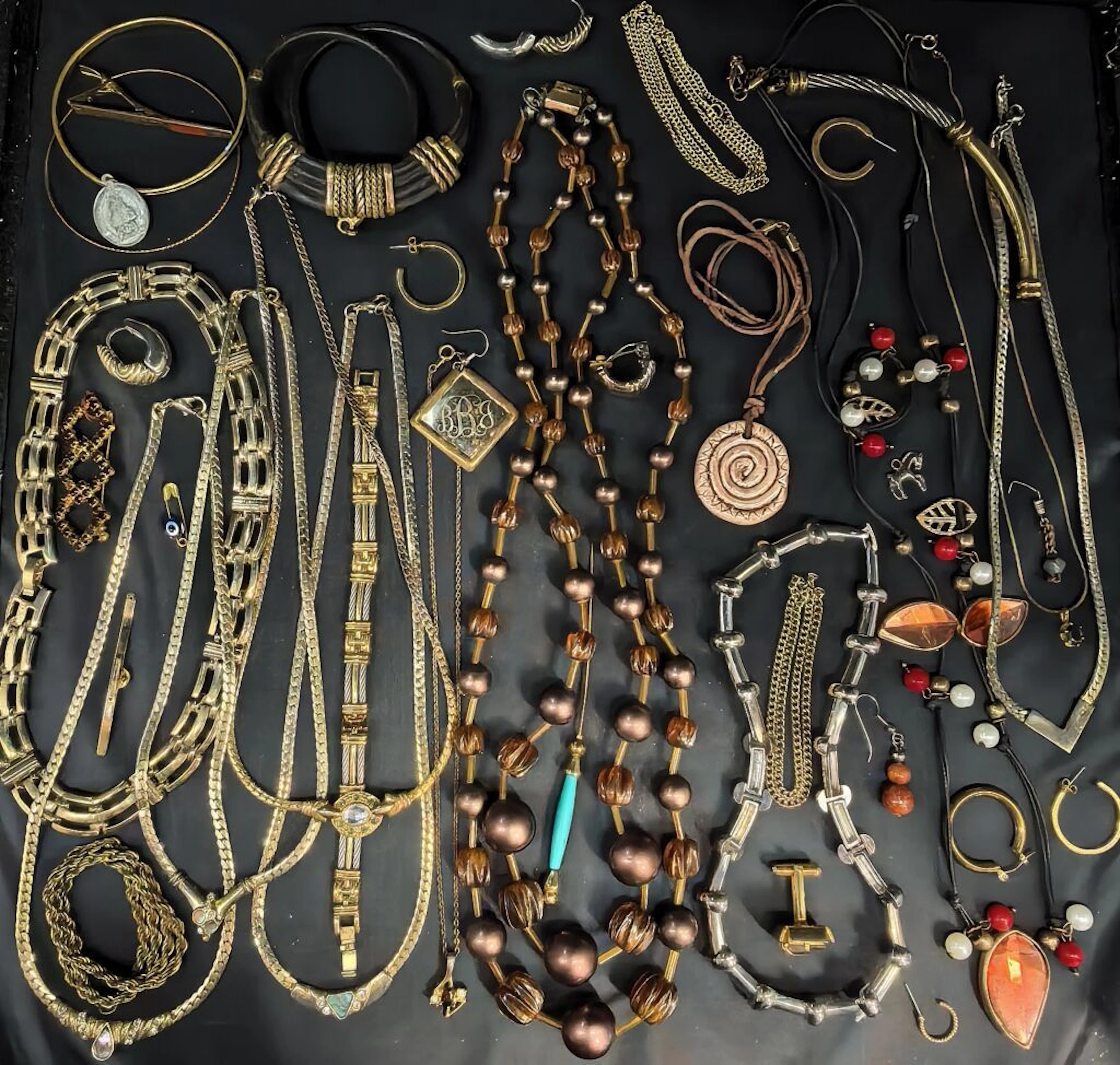 A collection of costume jewelry—including necklaces made of metal