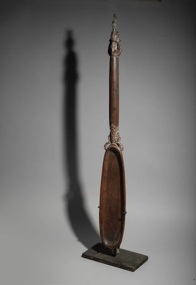 Ceremonial spoon with a long handle, decorated with two opposing heads