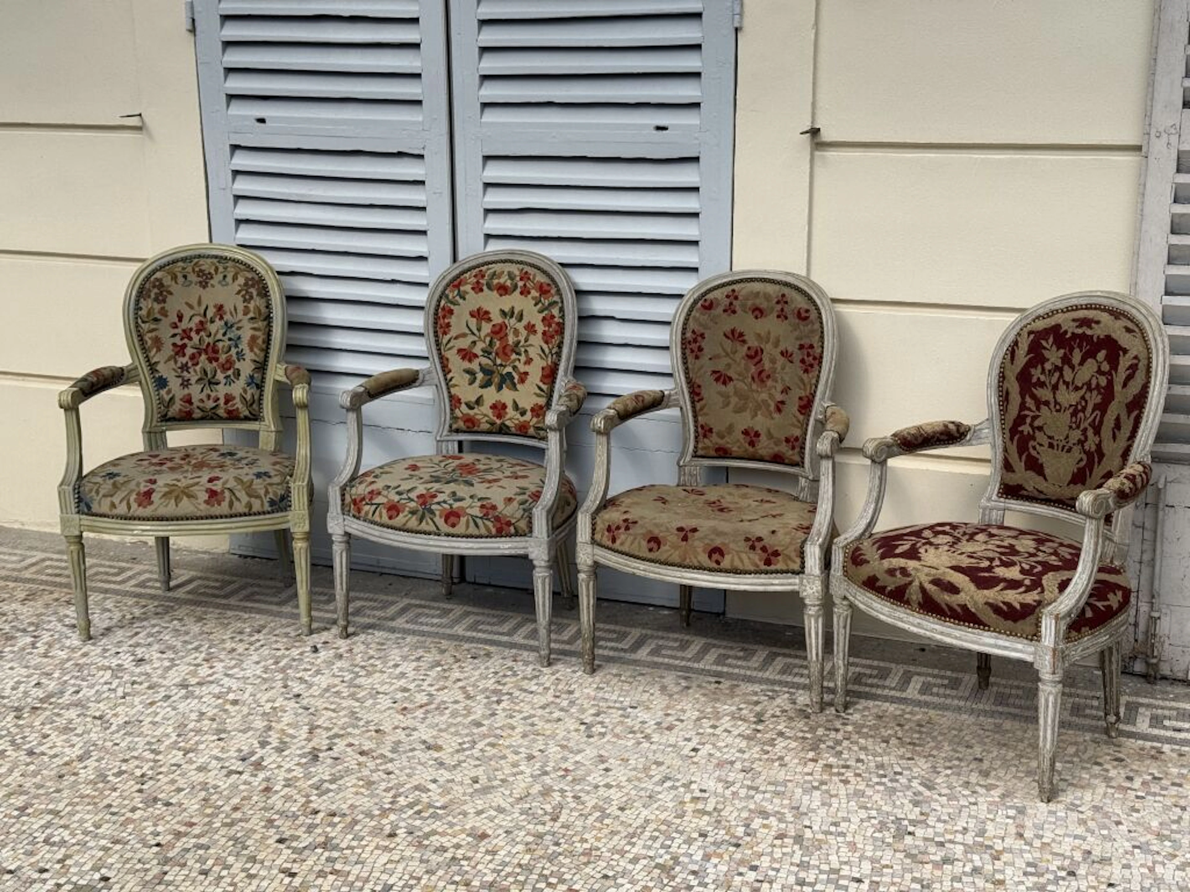 Four armchairs with cabriolet backs, made of molded, gray-lacquered