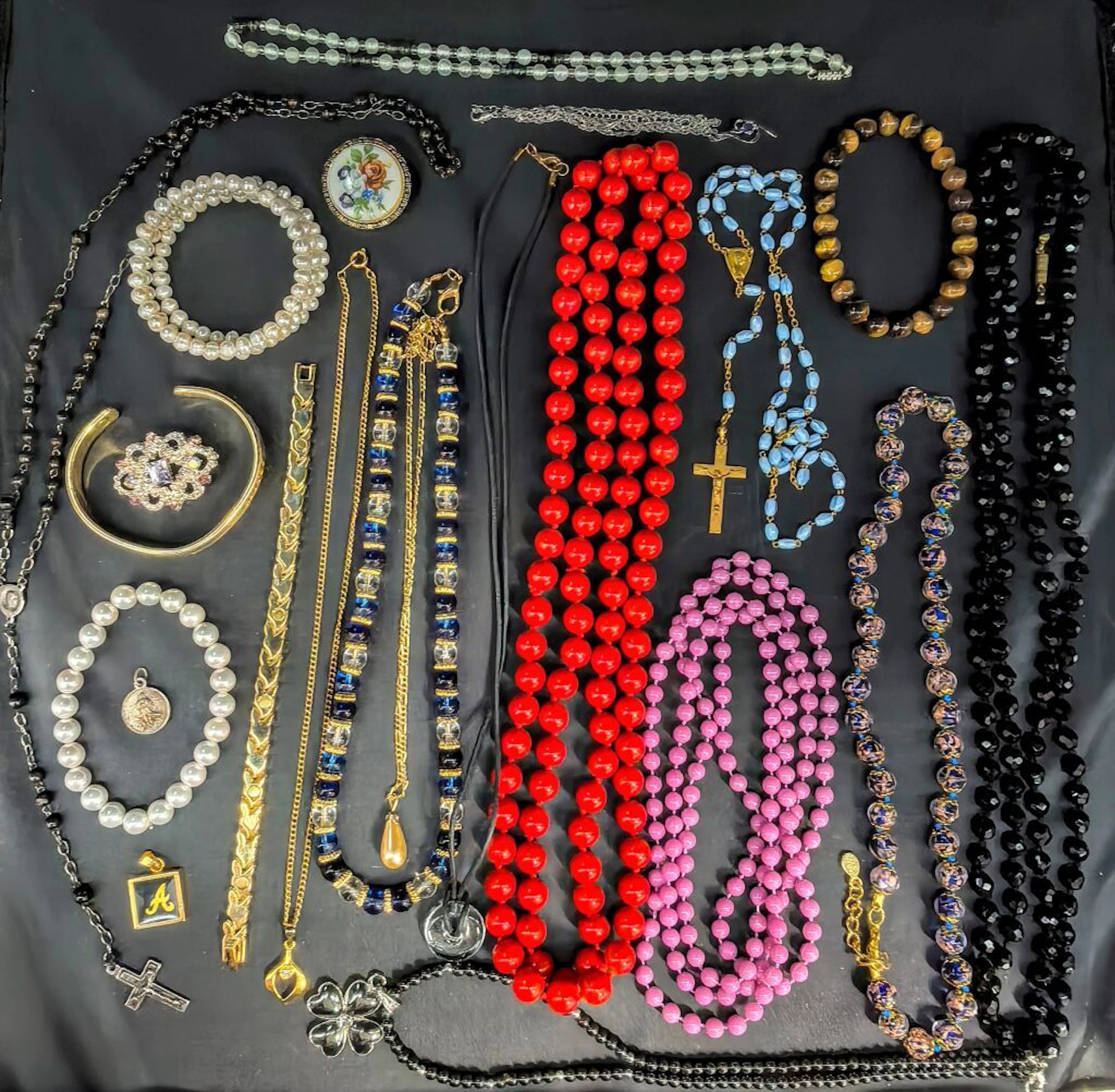 A collection of costume jewelry, including necklaces, pendants, etc.
