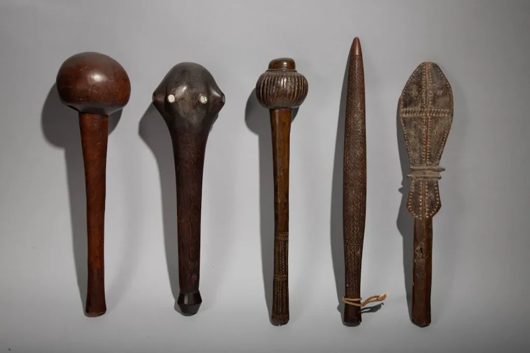 A short, lanceolate-shaped club with geometric decoration inlaid with