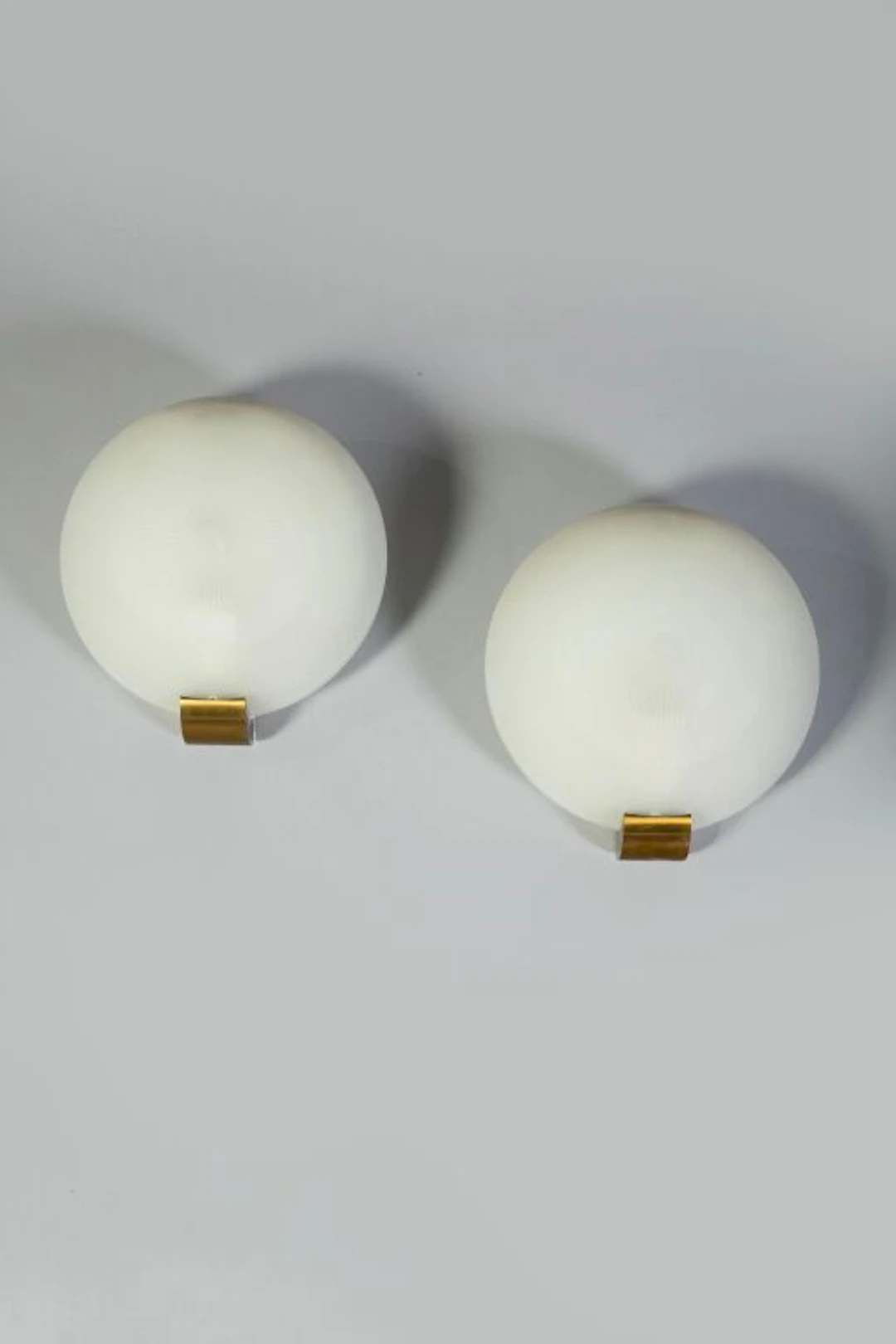 JEAN PERZEL WORKSHOP. Pair of circular wall sconces, model 1051, with