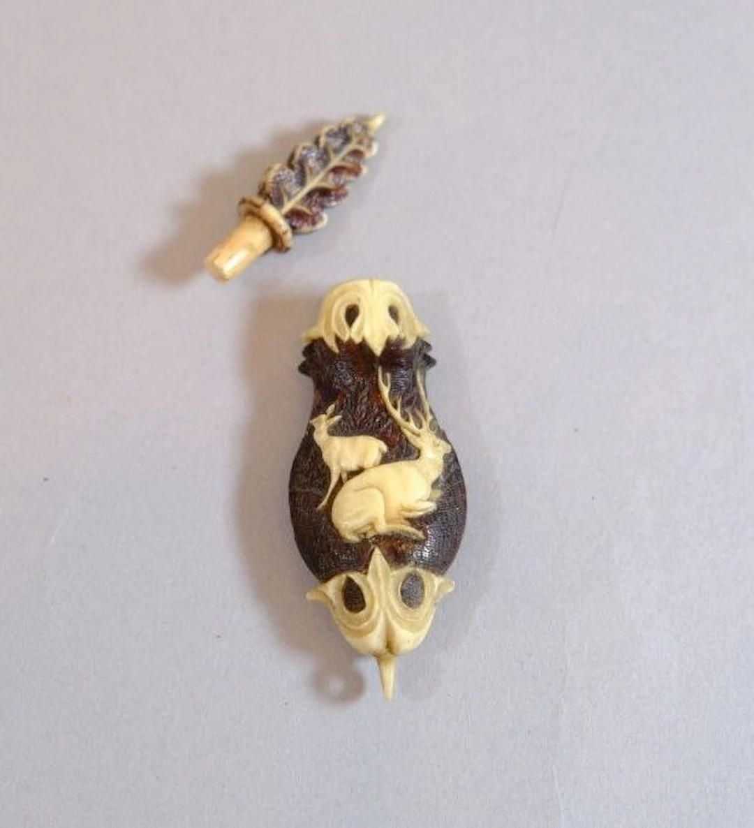A snuffbox made of bone, partially stained and finely carved with