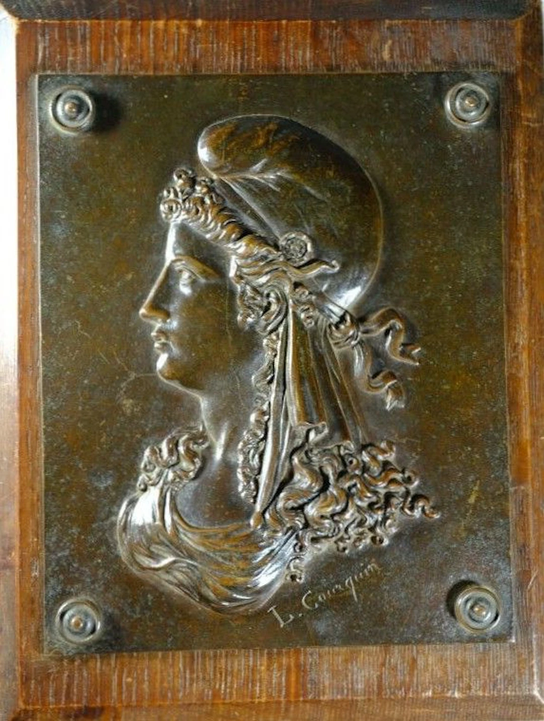 Marianne, bronze plaque mounted on an oak base. Signed "L. COURQUIN"