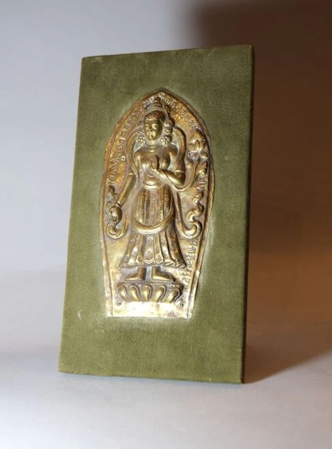 TIBET or NEPAL. A copper relief depiction of a deity making the gesture