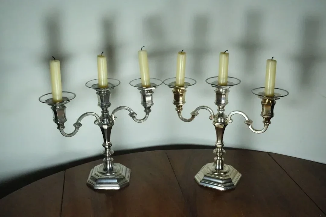 Pair of silver-plated metal table-end candelabras with three light