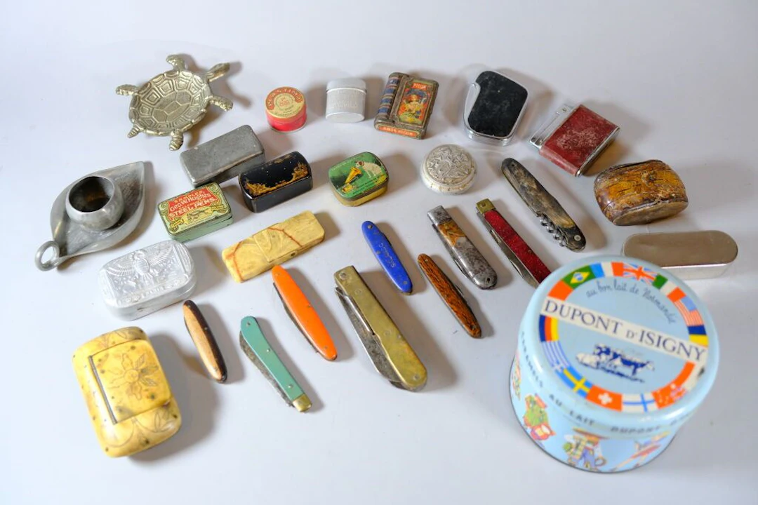 Assorted collection including miniature boxes, lighters, and pocket
