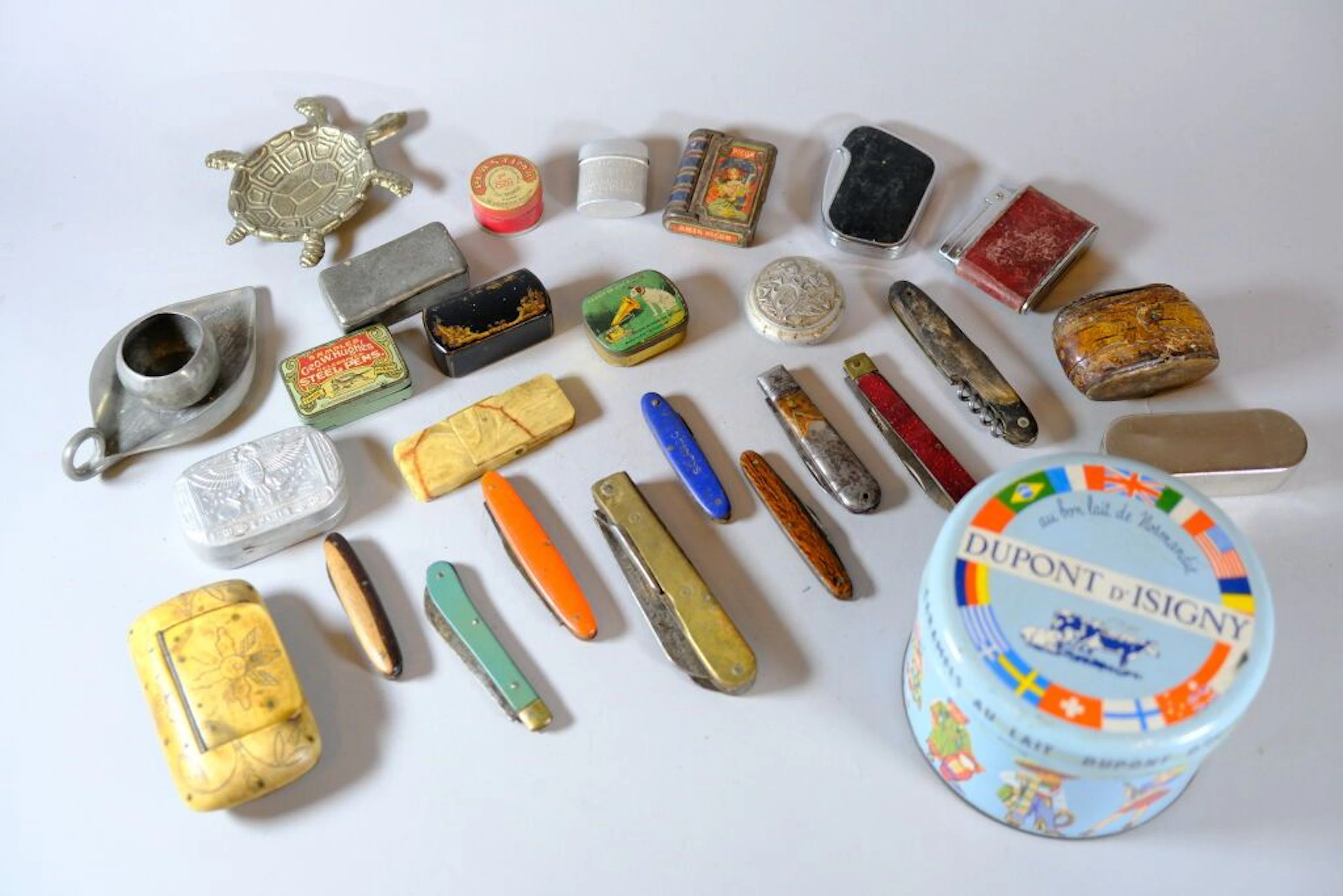 Assorted collection including miniature boxes, lighters, and pocket