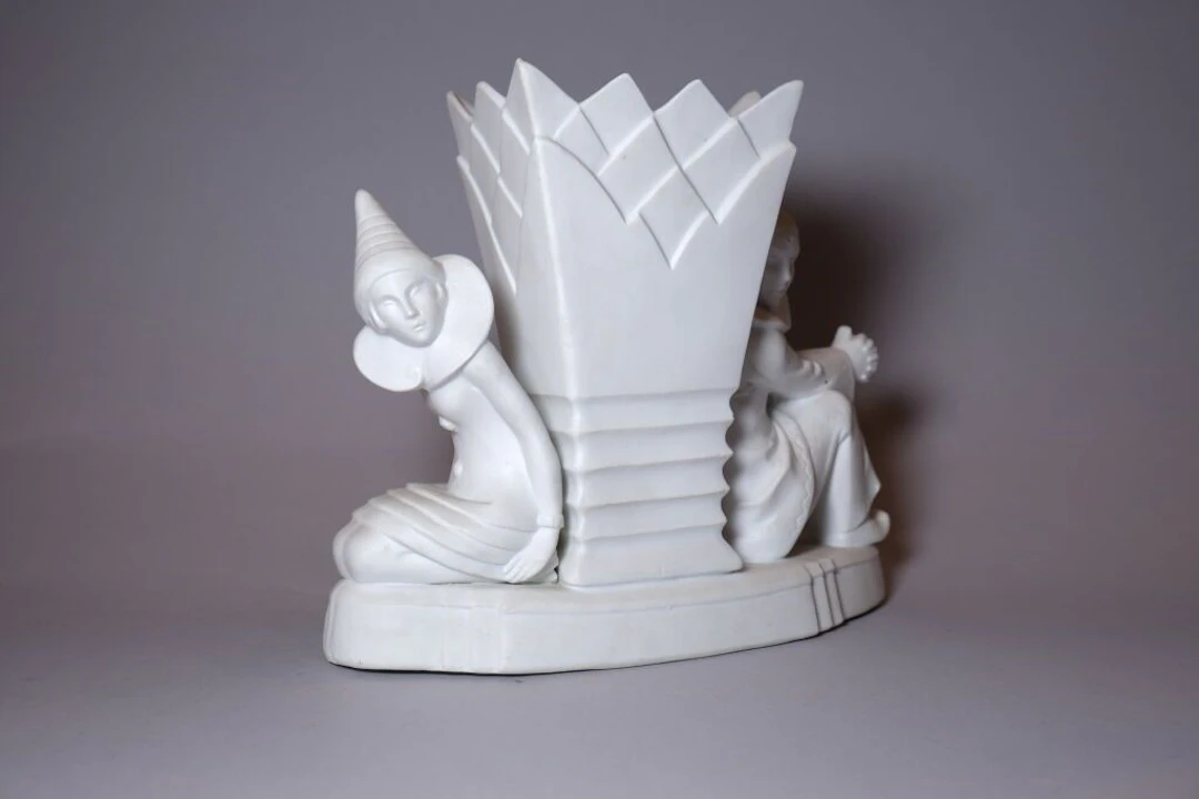 Porcelain bisque vase in the Sèvres style, flanked by Pierrot and