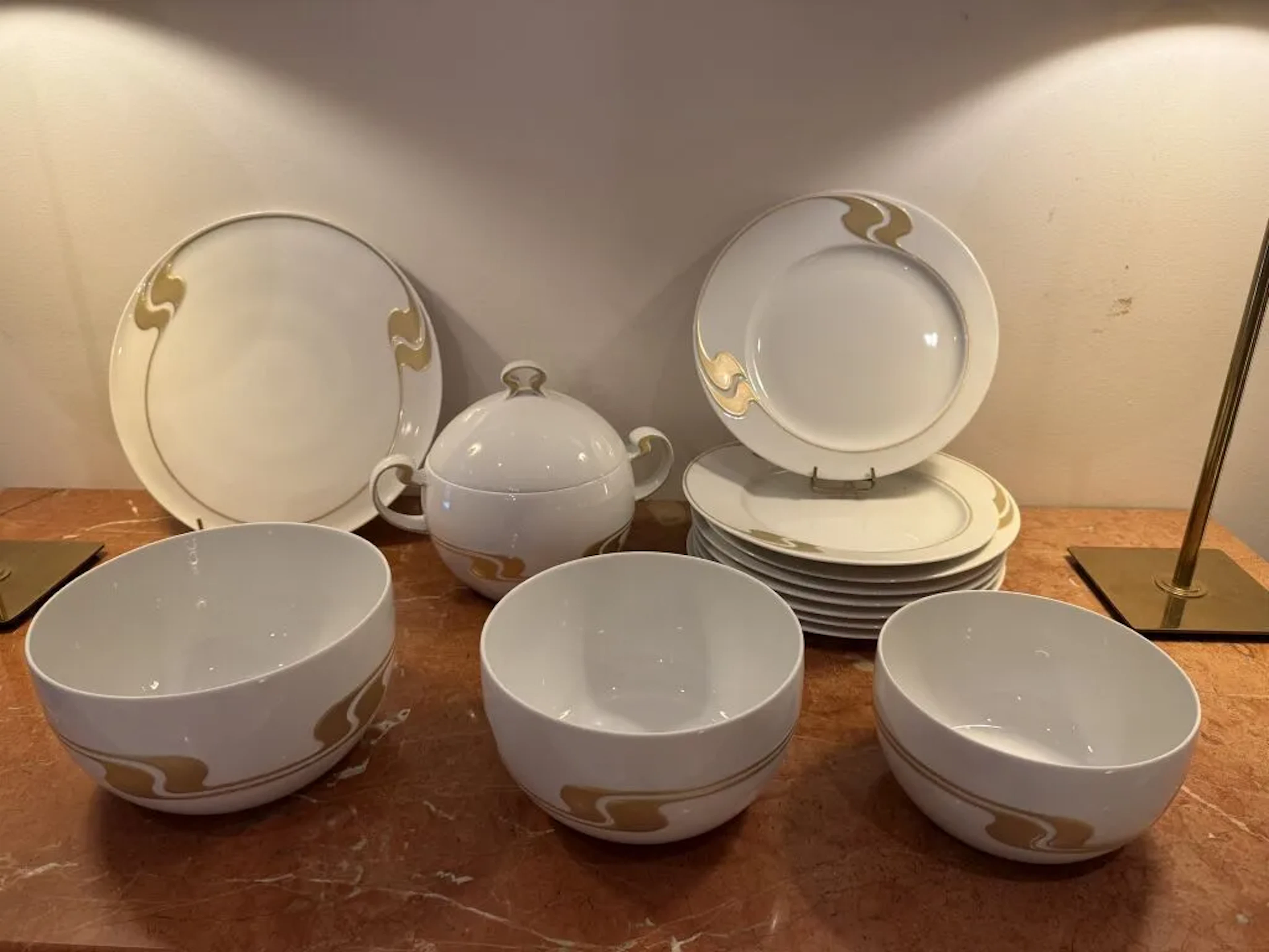 ROSENTHAL. Porcelain dinner service with a gold-accented design featuring