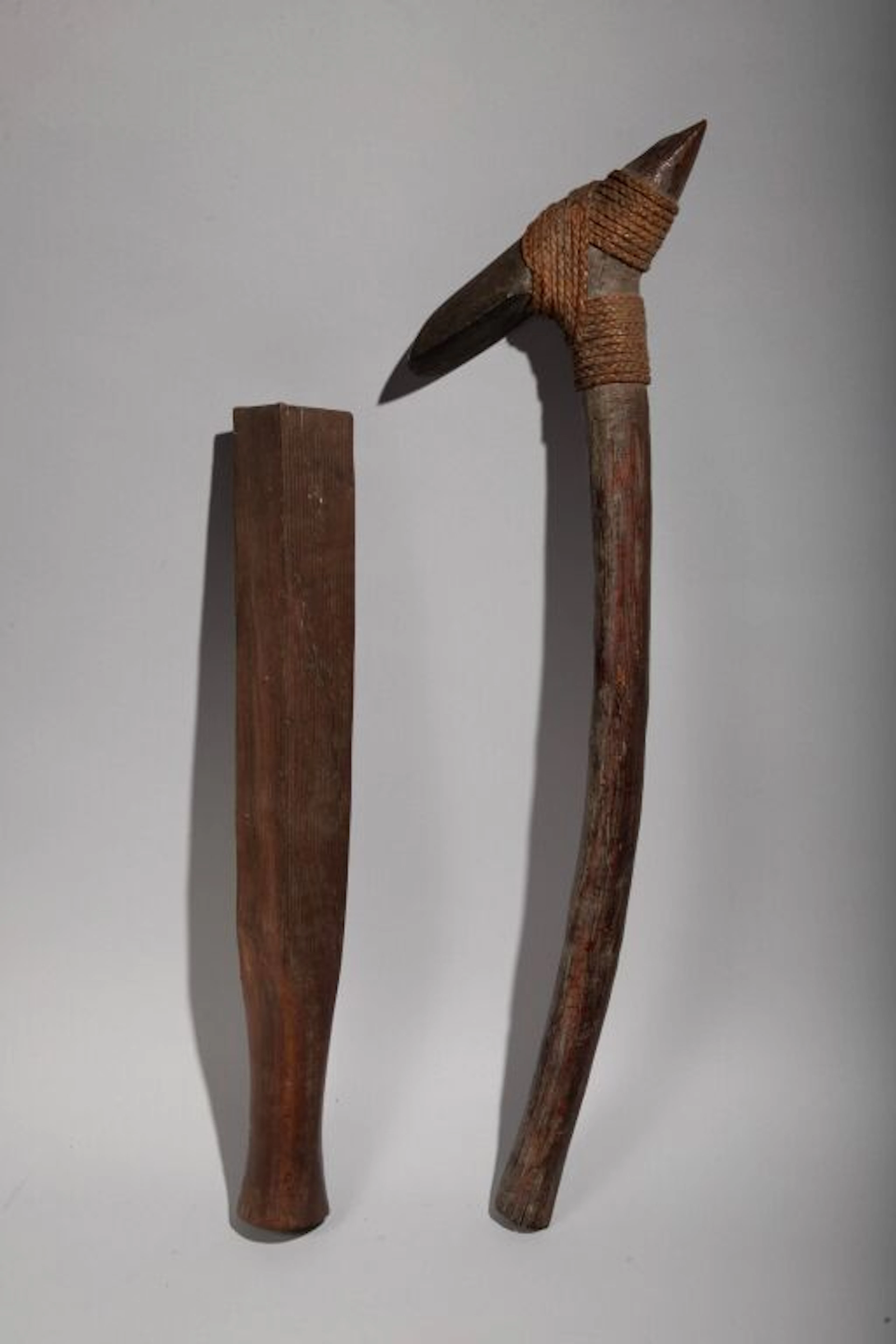 A quadrangular tapa mallet with fine grooves on each side. Hardwood.