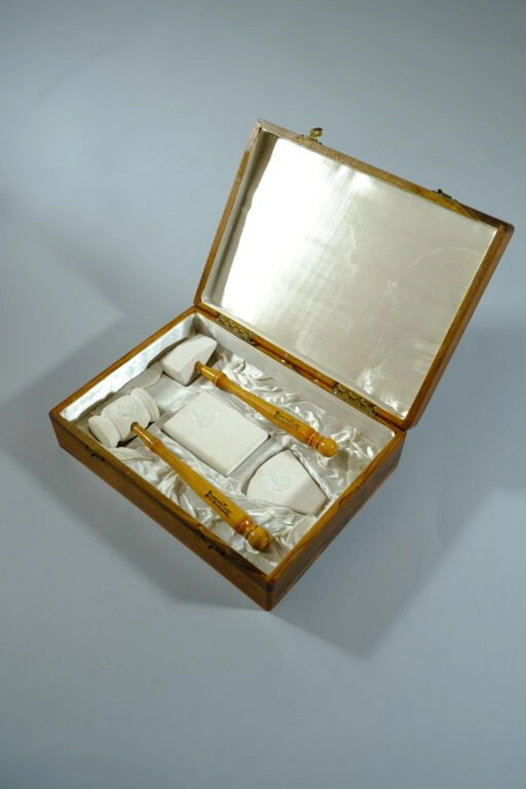 An olive wood box engraved with the compass and square, containing