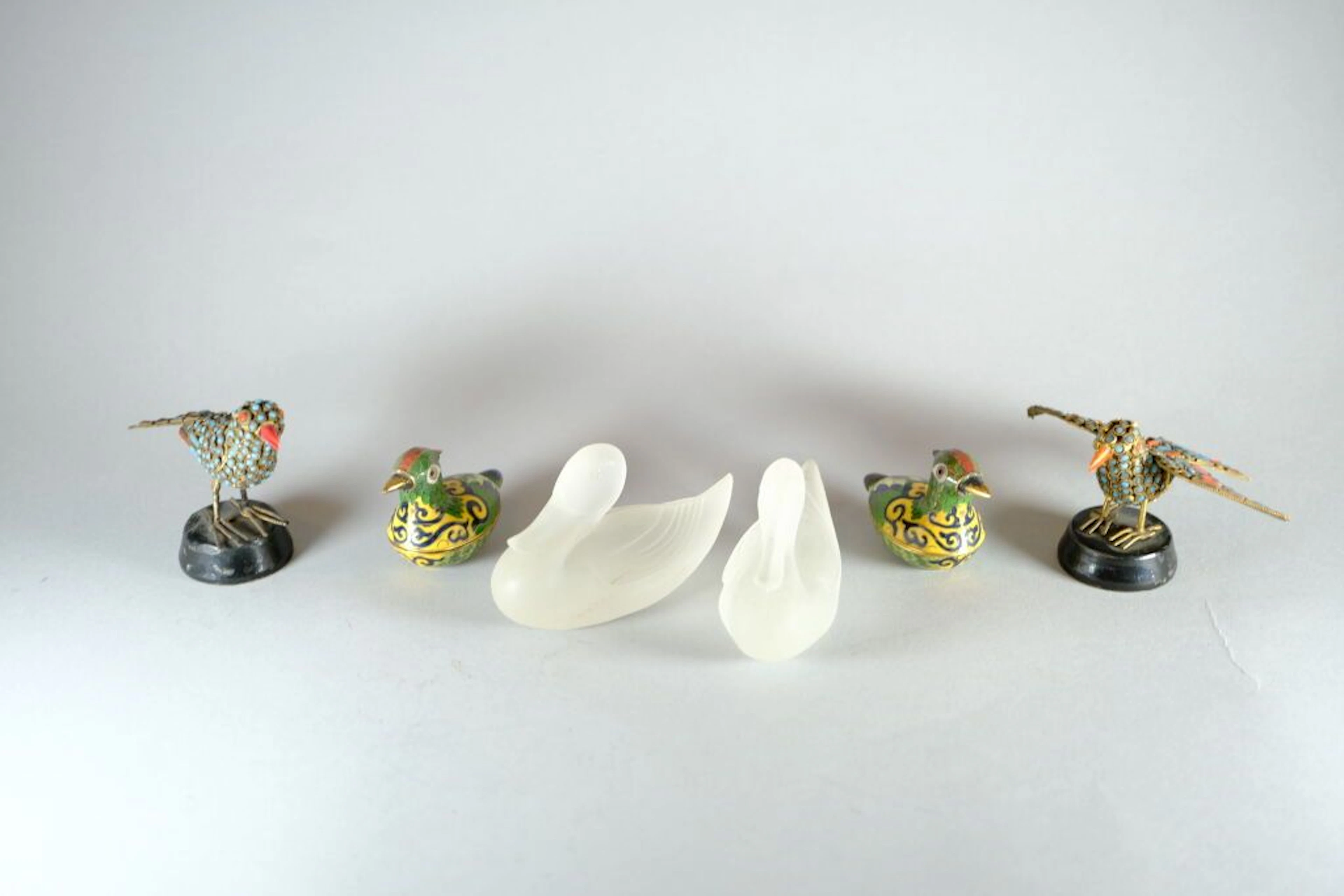 A set of animal-themed pieces featuring birds, including: - Two metal