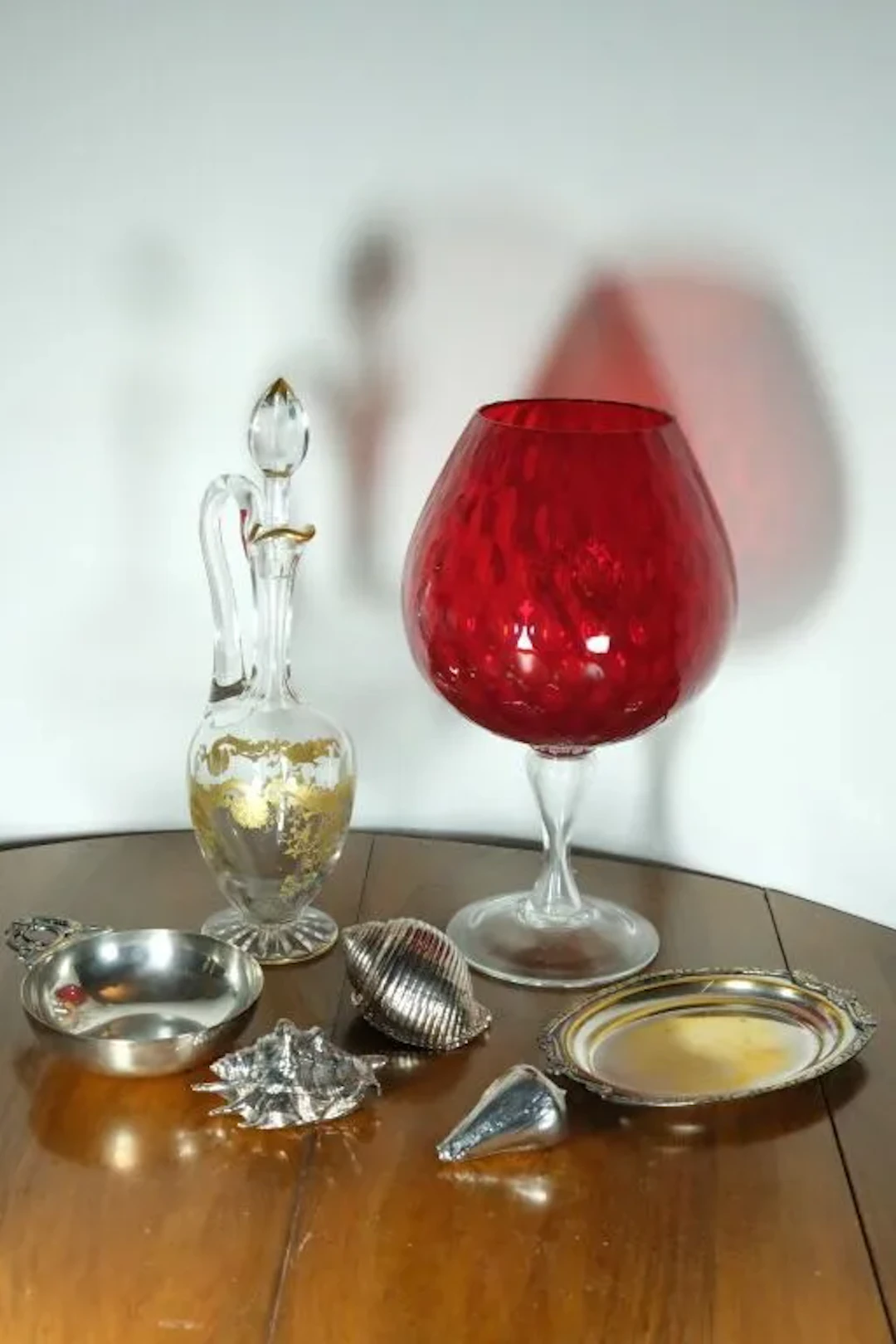 A small set of silver plated display items consisting of: a wine taster