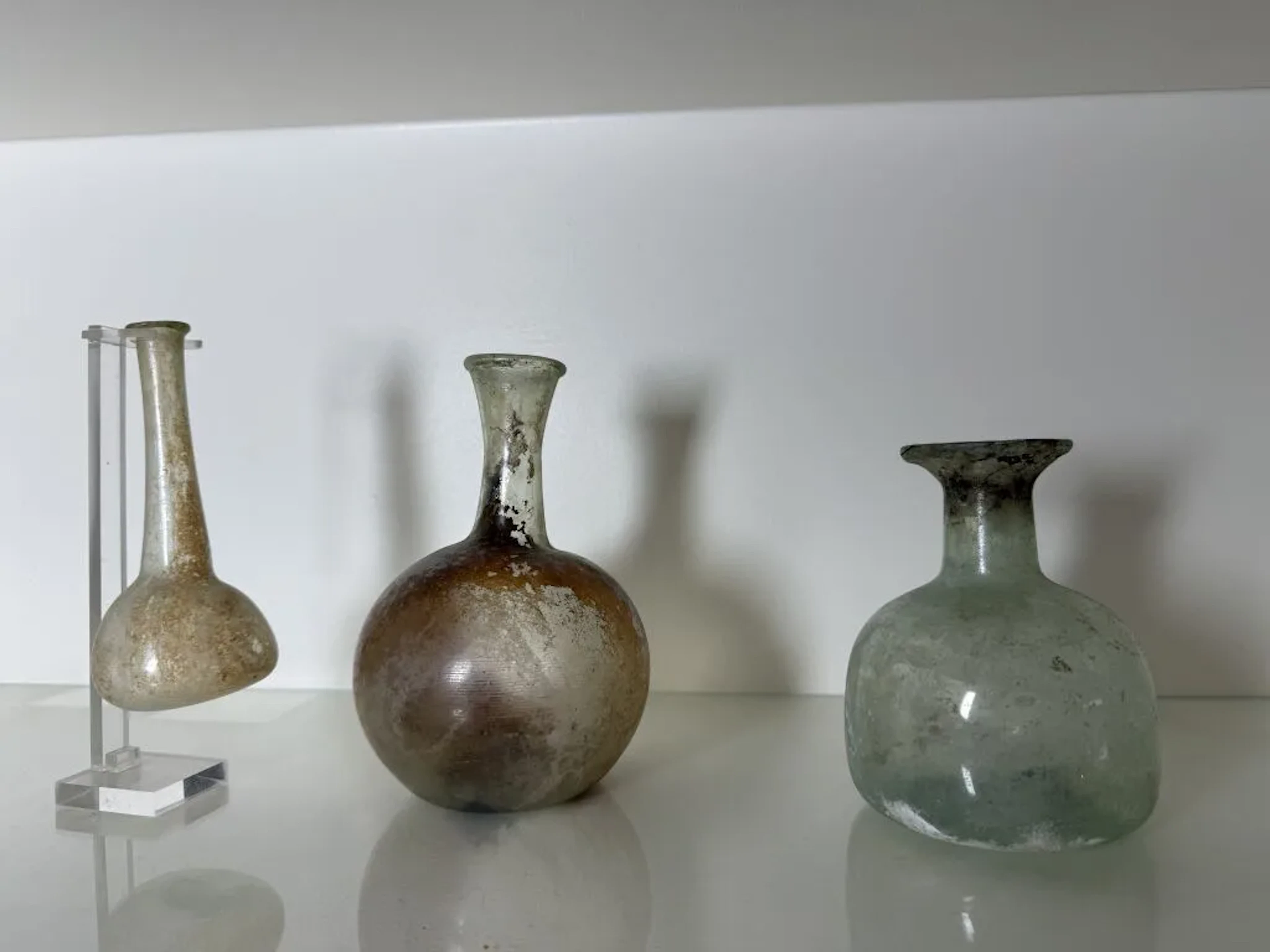 Set of three glass vases or flasks in the antique style. Height of