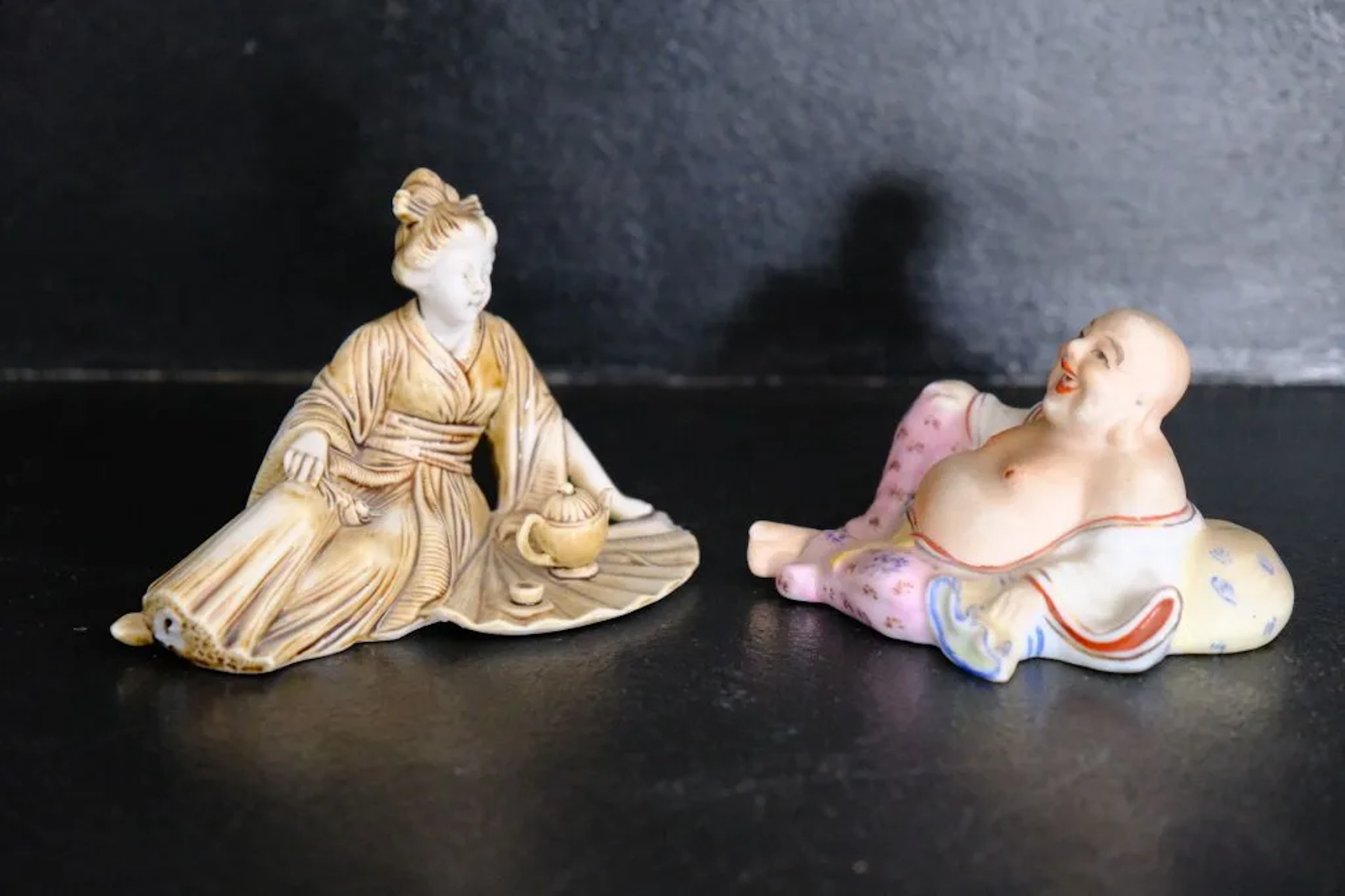 Two Asian porcelain or bisque figurines, one depicting a monkey (marked