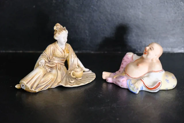 Two Asian porcelain or bisque figurines, one depicting a monkey (marked