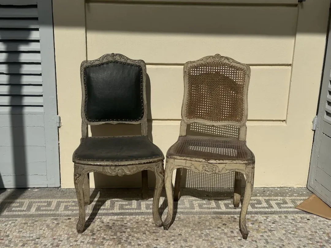 Pair of gray-refinished wooden chairs with carved foliage and floral